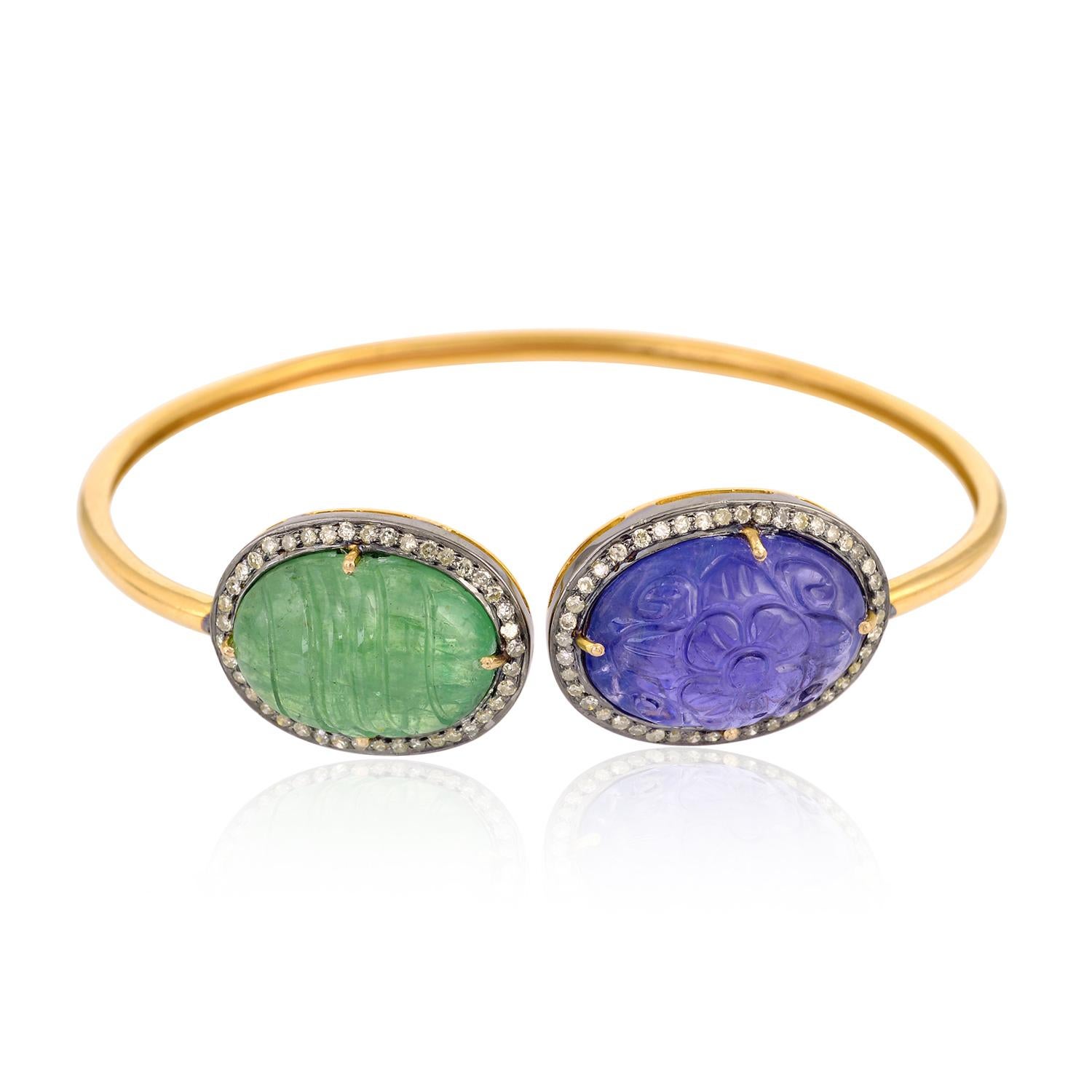 Designer Twistable Carved Tanzanite, Tsavorite and Diamond Bangle in 18k Yellow Gold perfect to have some fun this season under the sun! 

14kt:4.43gms
Diamond:0.61cts
Silver:2.25gms
Tanzanite:13.49cts
Tsavorite:14.10cts
