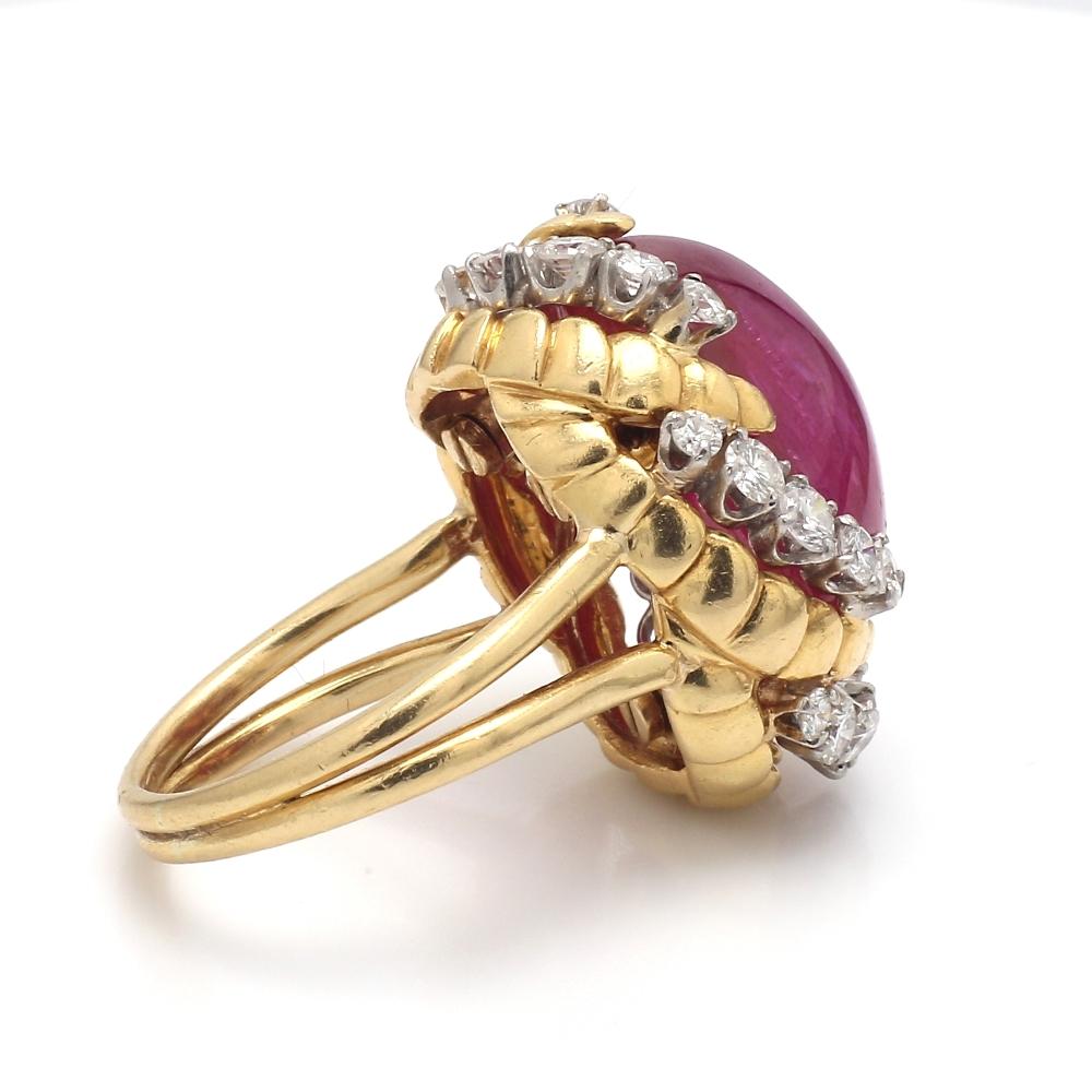 Van Cleef and Arpels, platinum, ruby ring. Center stone is one ( 1 ) oval, cabochon cut, no heat, Burma ruby weighing approximately 30.00ct. Ruby is accompanied by an American Gemological Laboratory Report #1101401. Ring is set with twenty-five (25)
