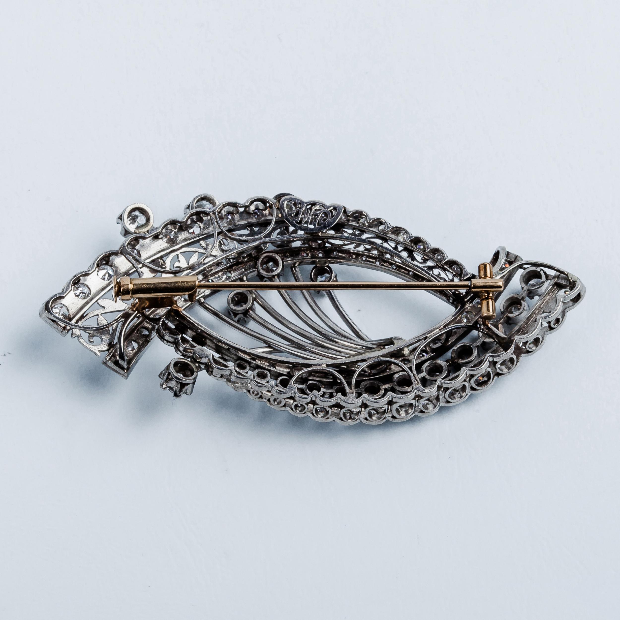 Designer CAMPS vintage brooch in platinum and clean white diamonds 
Slimline design of two opposing curves made of  diamond bands and twigs with claw setting and openwork plant motifs in matt finishing.

MATERIAL
◘ Yellow Gold Pin
◘ Size 70mm / 2,75