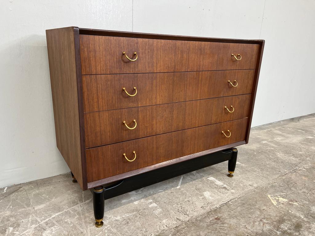 Original Large 1950's designer chest of drawers. Made from teak and afromodia oak standing on ebonised legs, Lots of storage in the 4 drawers. Very stylish look. Well made, quality piece of furniture.

Measures: Height 76cm, depth 47cm, width 96cm.