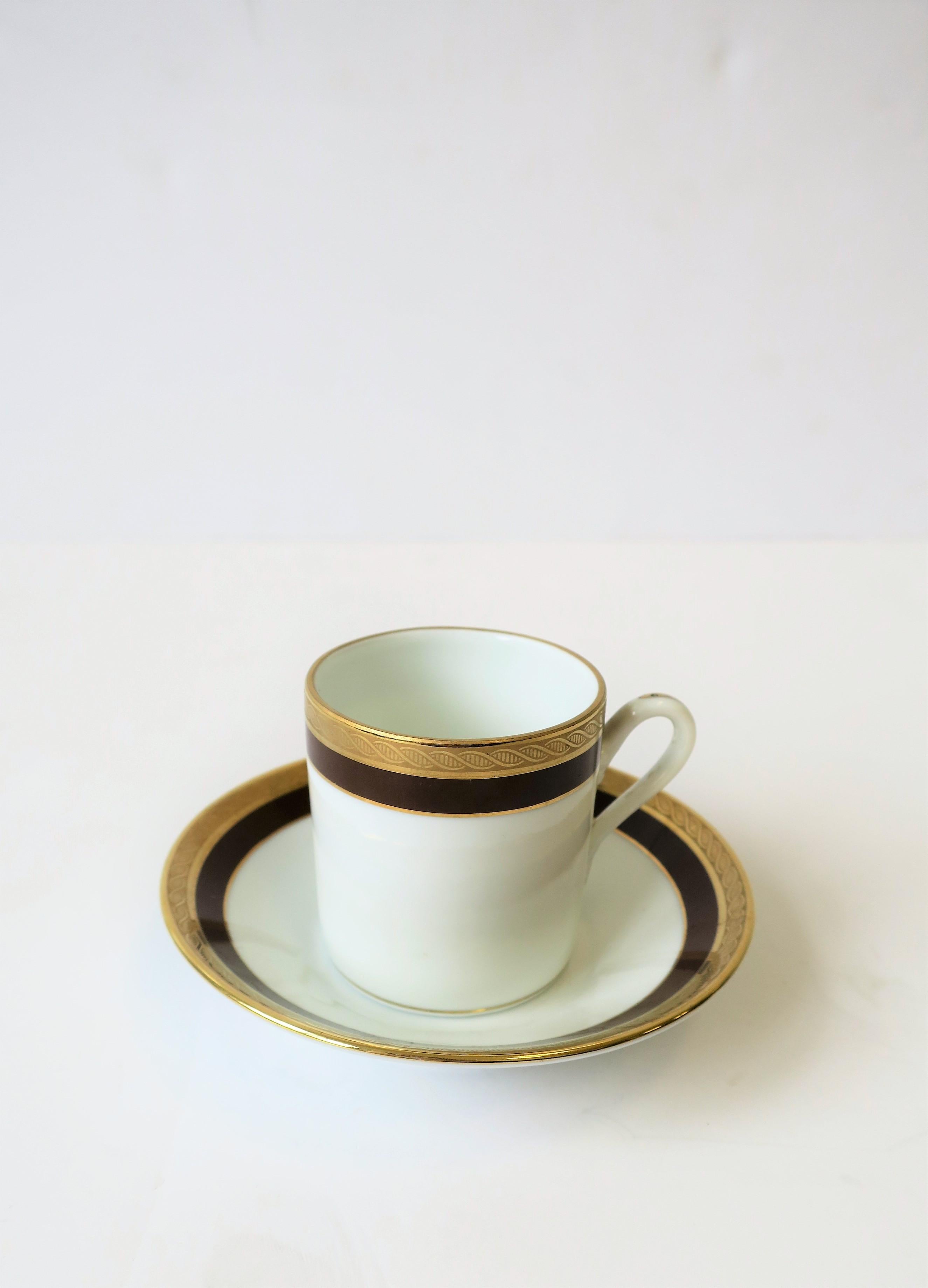 A beautiful Italian white porcelain and gold espresso cup and saucer by designer Richard Ginori, with decorative gold band detail, circa mid-20th century, Italy. Colors include chocolate brown, white and gold. With maker's mark on back as show in