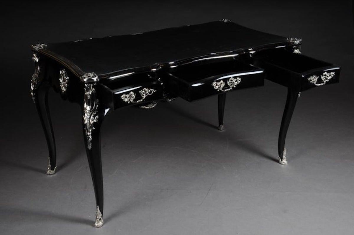 Schwarzer Designer-Schreibtisch / Bureau plat im Louis XV-Stil

Klavierschwarzes, poliertes Furnier auf massivem Weichholz mit Rocaille-Applikationen. Sehr feine, florale, versilberte Bronzebeschläge in Form von Rutschen, Griff aus patinierter