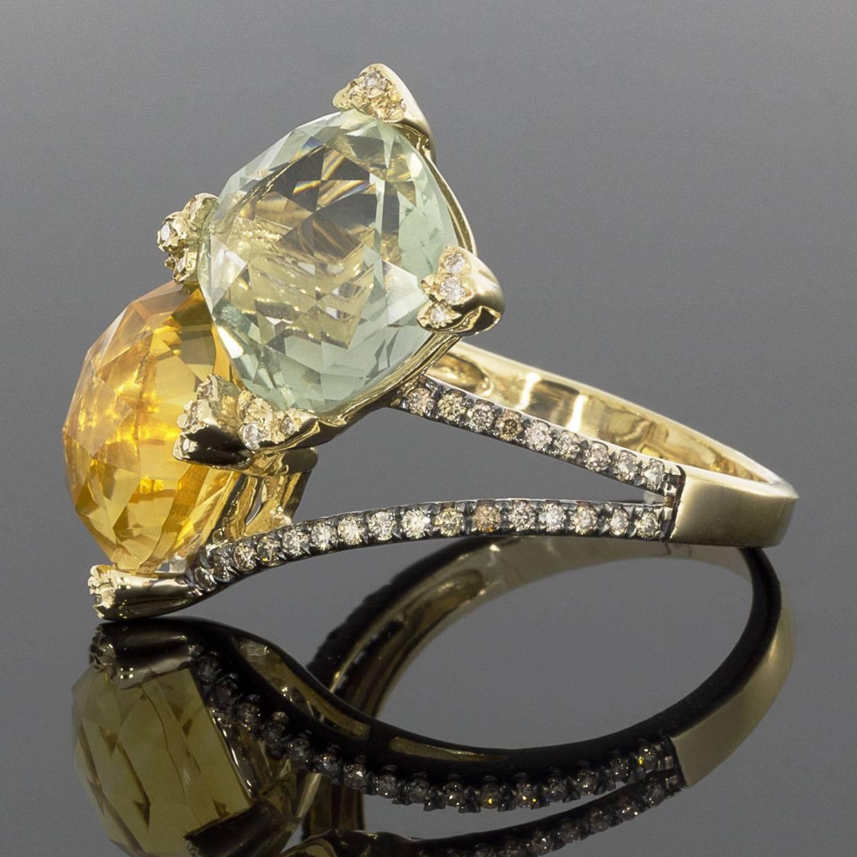 This beautiful 14K yellow gold, royal citrine, green amethyst, and diamond ring is sure to wow! This ring features a cushion cut green amethyst and a cushion cut royale citrine with checkerboard faceting. The gemstones are held in place by clover
