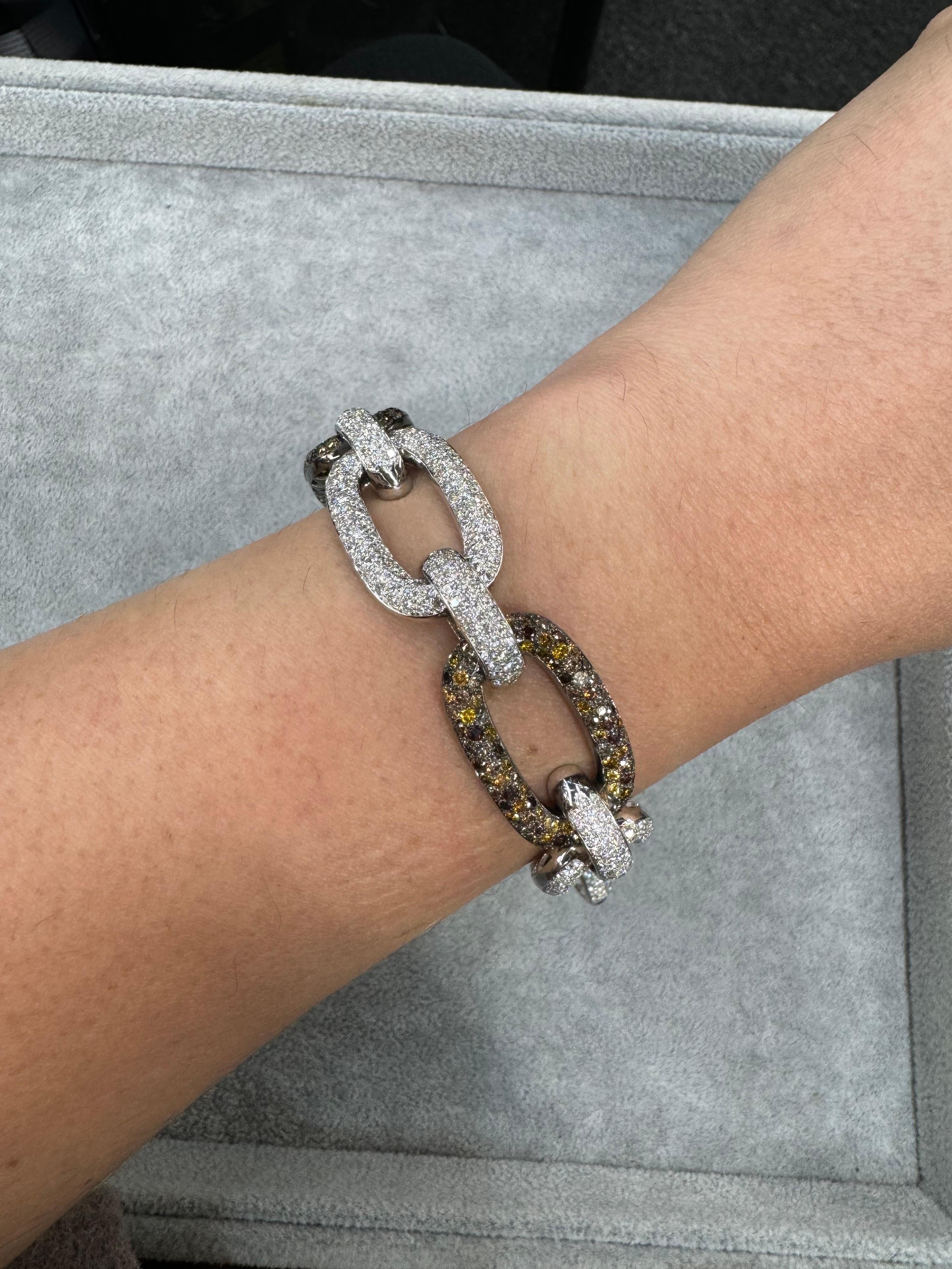 Signed Yeprem, this alternating link bracelet features 491 high quality round brilliance weighing 14.73 carats and 264 Champagne color diamonds weighing 13.20 carats, in 18 karat white gold. 

All diamond weights are approximate.
Evaluated by a GIA