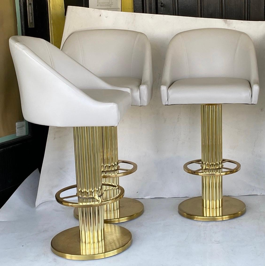 Five Designs for Leisure barstools… On a neoclassical brass base.. recently reupholstered with high-grade gray vinyl… bar stools.