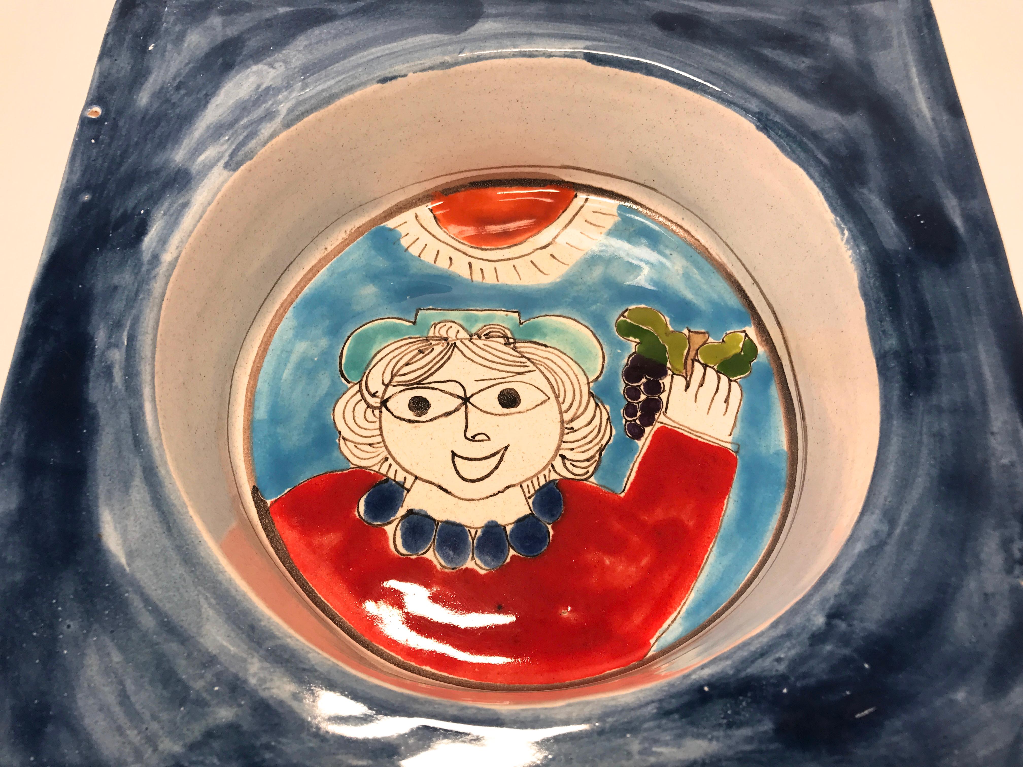 DeSimone of Italy, 'Happy Grape Lady' is typical of DeSimone's colorful and playful art.
This bowl is weighty, deep and square - a most unusual piece for the DeSimone collector 
circa 1960s
Signed DeSimone, Italy 102 on reverse
Measures: Height