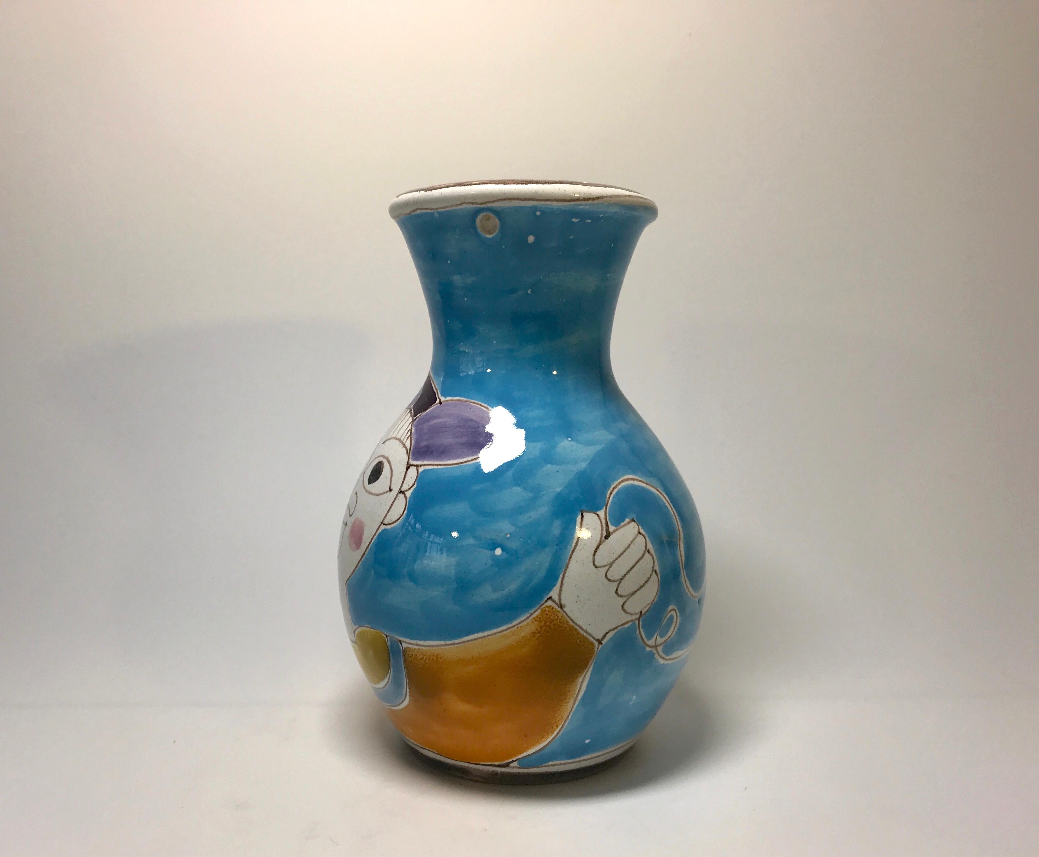 DeSimone of Italy, hand painted shaped ceramic vase of a boy and his red spinning top
A fun vase from DeSimone,
circa 1960s
Signed DeSimone, Italy
Measures: Height 5.5 inch, diameter 3.25 inch
Good condition and joyful colors. Small hole from