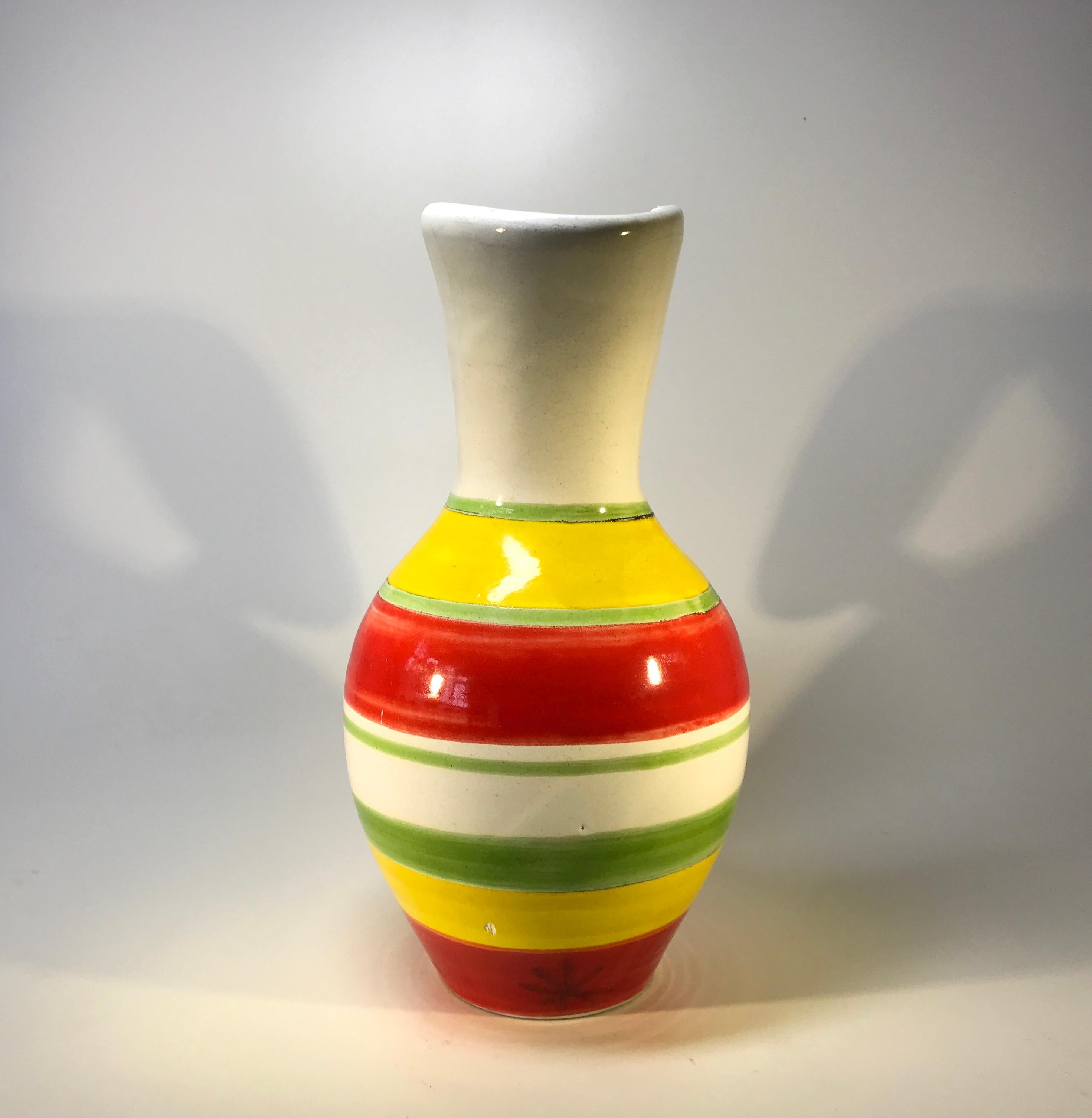 DeSimone of Italy, tall ceramic pitcher hand decorated with brightly coloured red, yellow and green stripes
Intriguing neck shape - an appealing, cheerful piece from DeSimone,
Circa 1960's
Signed DeSimone, Italy
Measures: Height 9 inch, width