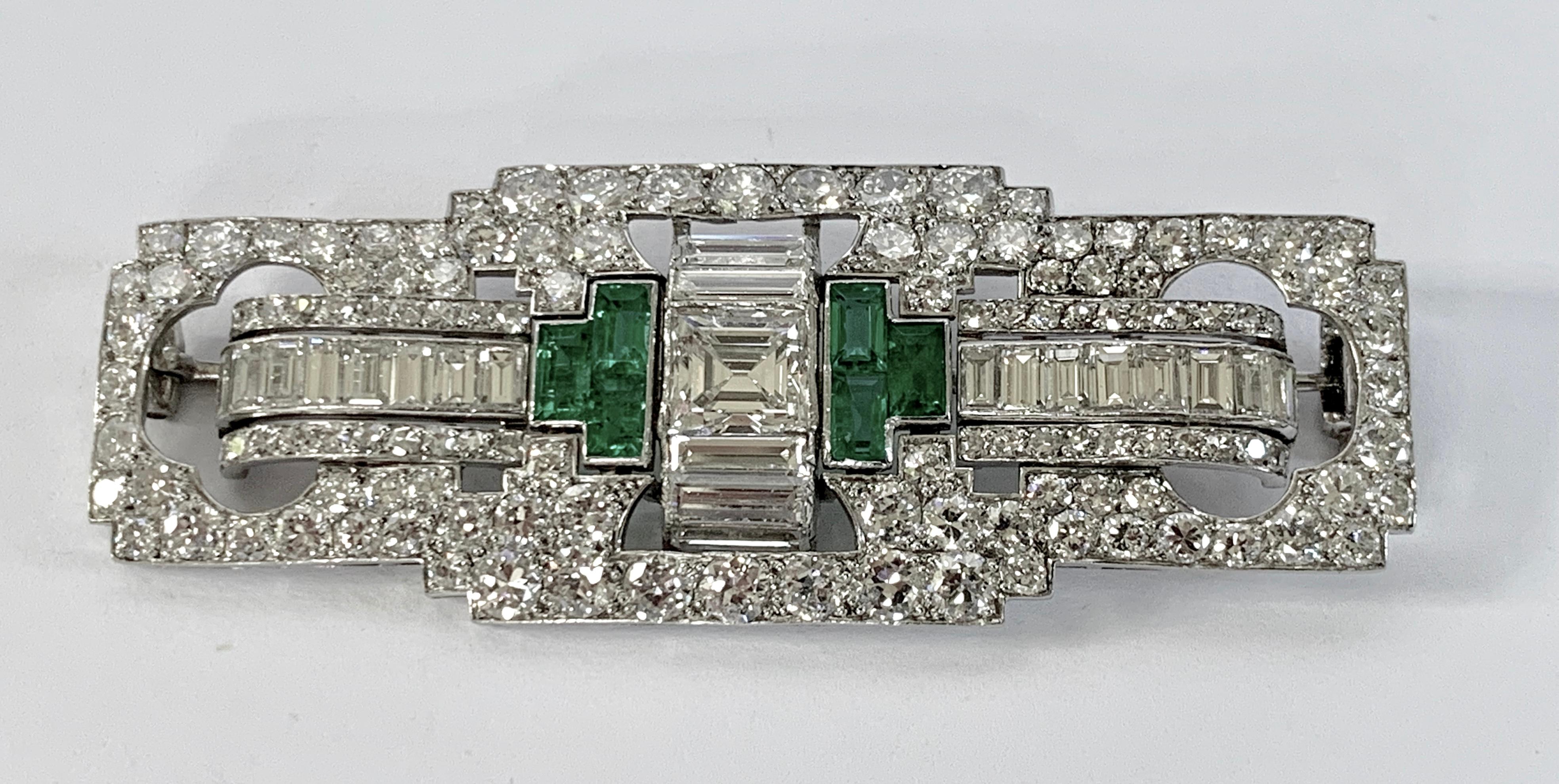Art Deco Platinum  Emerald and Diamond pierced openwork geometric plaque pin brooch, C.1930. Centrally set with emerald cut diamond of approximately 1.00  carat surrounded by pierced openwork platinum sections set with 22 baguettes and 126 diamonds,