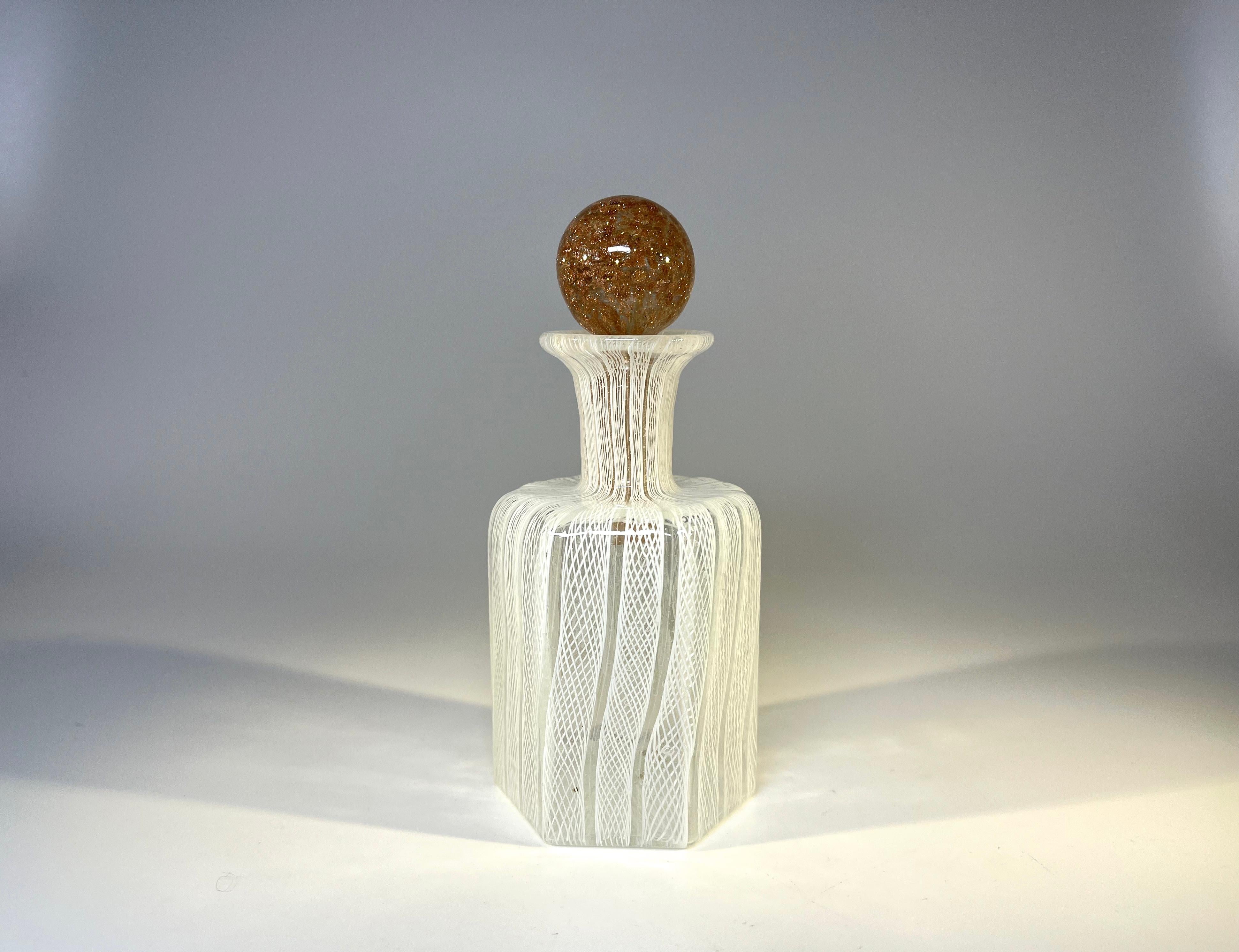 Pure white Venetian ribbons adorn this latticino Murano glass perfume bottle.
An unusual shaped bottle with an unexpected aventurine stopper.
Certainly a desirable piece of Venetian glass work.
Circa mid-century.
Measures: height 4.75 inch,