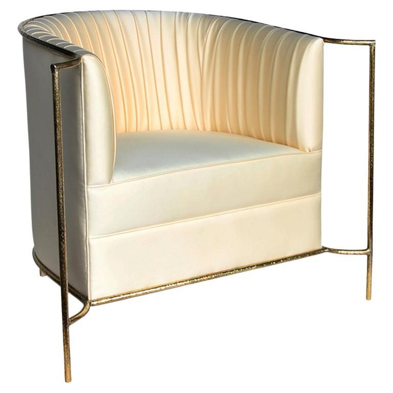 Ignite your desire to be wanted in the comfort of this provocative, fully upholstered pleated chair. A textured, hammered metal band outlines its curves the way the mind outlines the female desire.