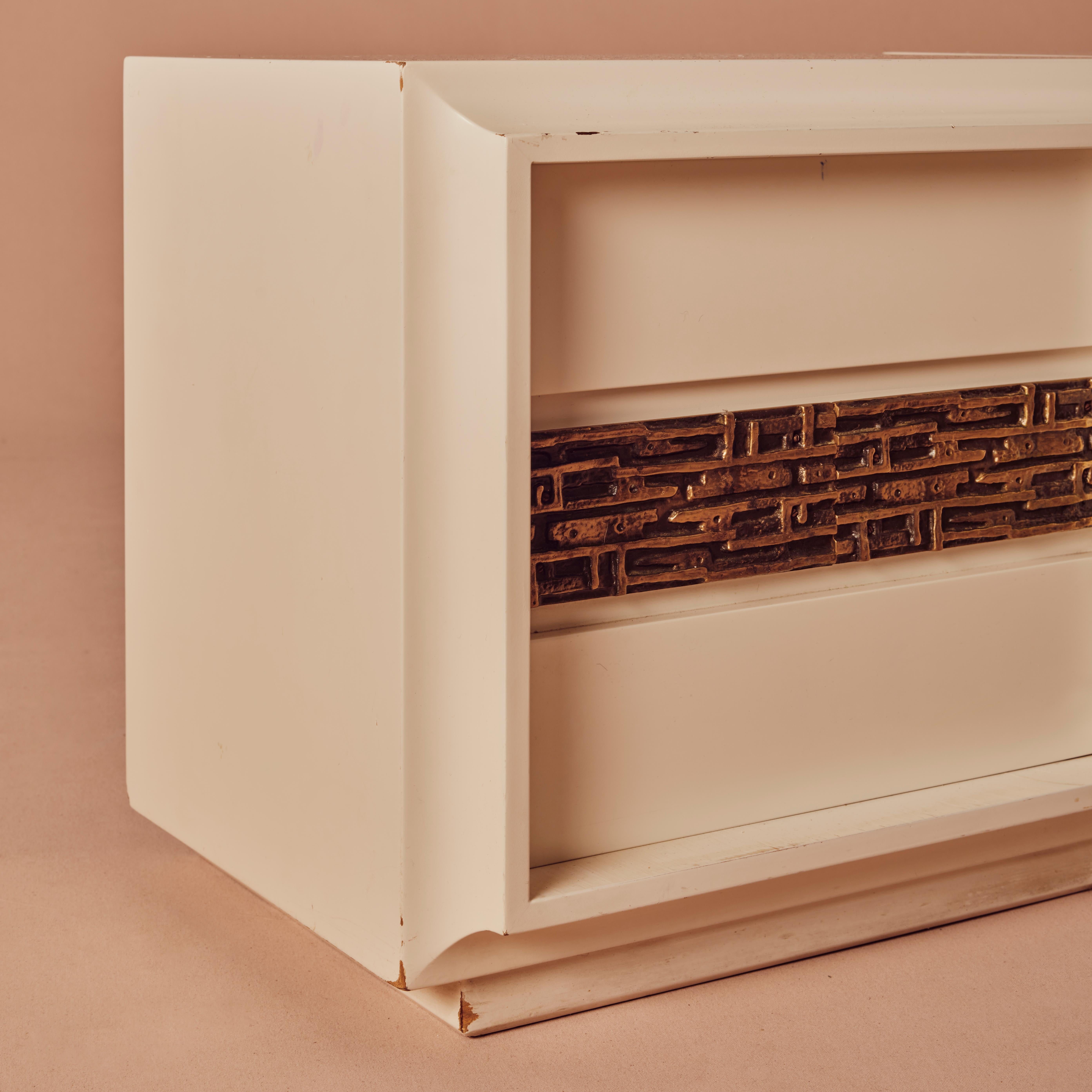The pair of bedside tables from the Desirée series, a stylish and elegant furniture set produced around 1970 by Frigerio di Desio. 
These bedside tables are crafted from lacquered wood and feature bronze castings, which add a touch of sophistication