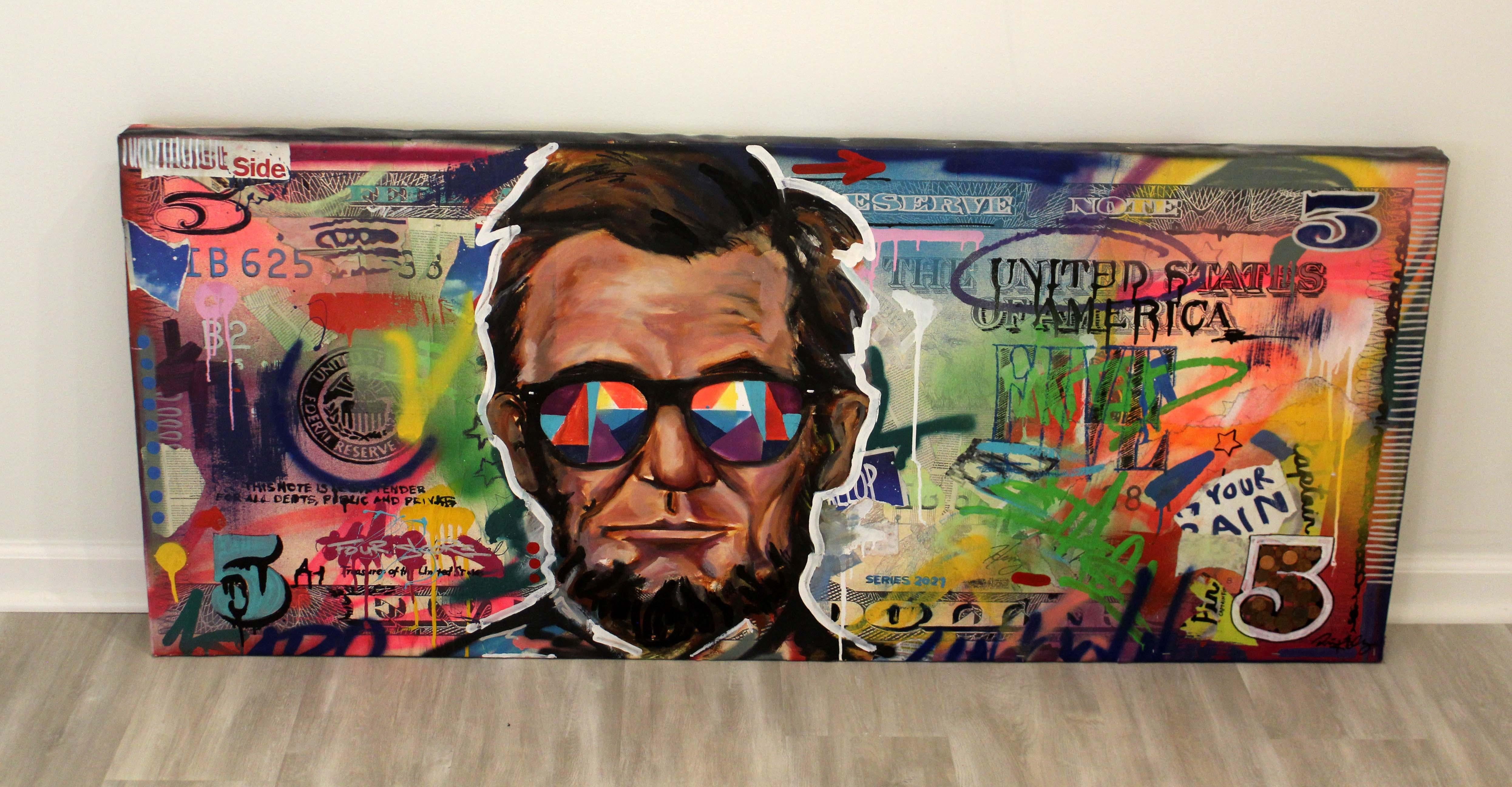 A signature style spray paint with collage artwork on canvas by Detroit’s urban artist Desiree Kelly, titled Abe Money Bill. A similar mural titled Abe in Shades was installed in downtown Royal Oak. Kelly portrays the 16th president on the $5 bill