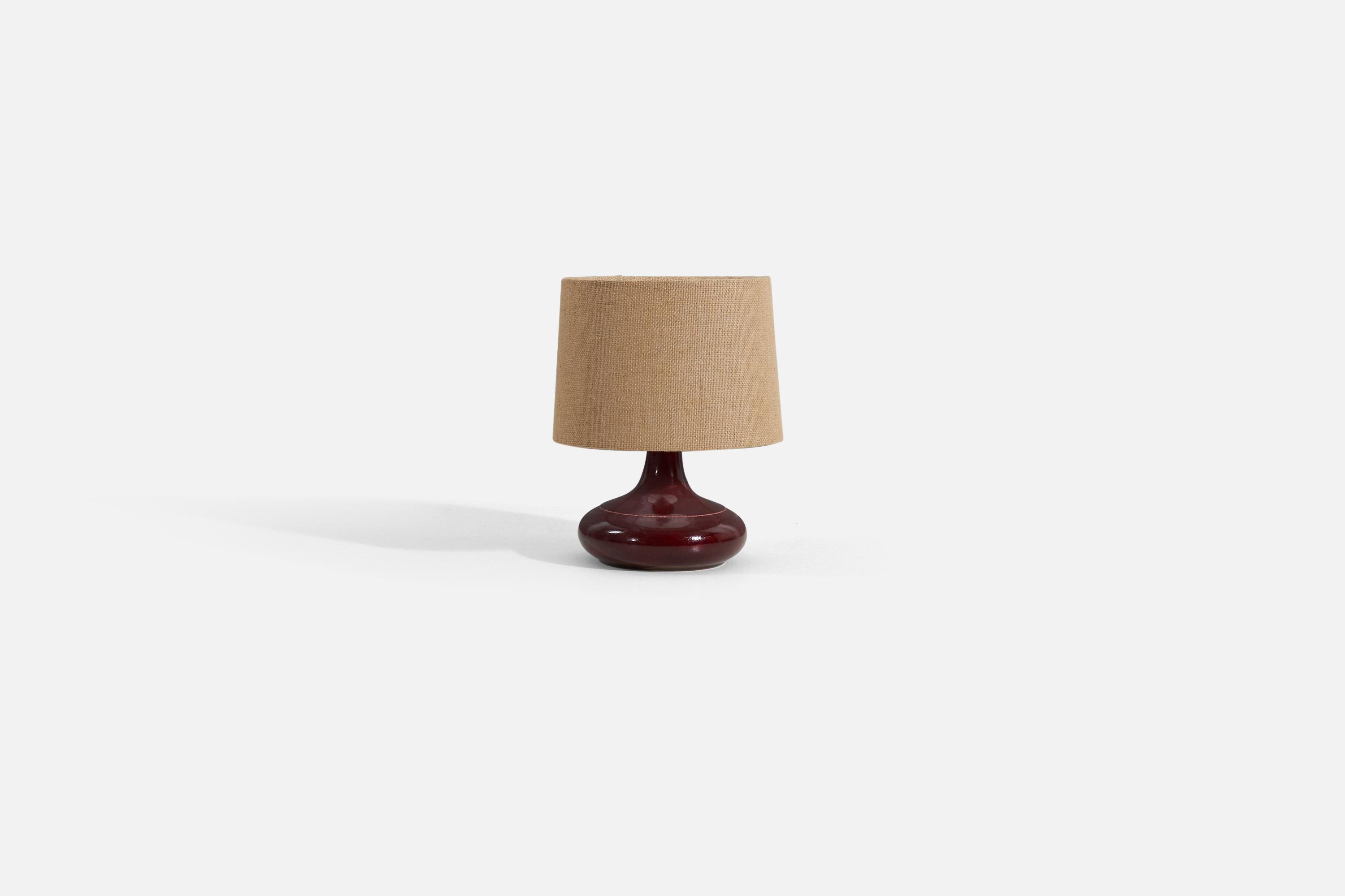 A red / Burgundy table lamp, designed and produced by Desiree Stentøj, Denmark, 1960s. stamped to underside.

Sold without lampshade. Stated dimensions exclude lampshade. Height includes socket. Below dimensions for reference: 

Shade : 9 x 10 x