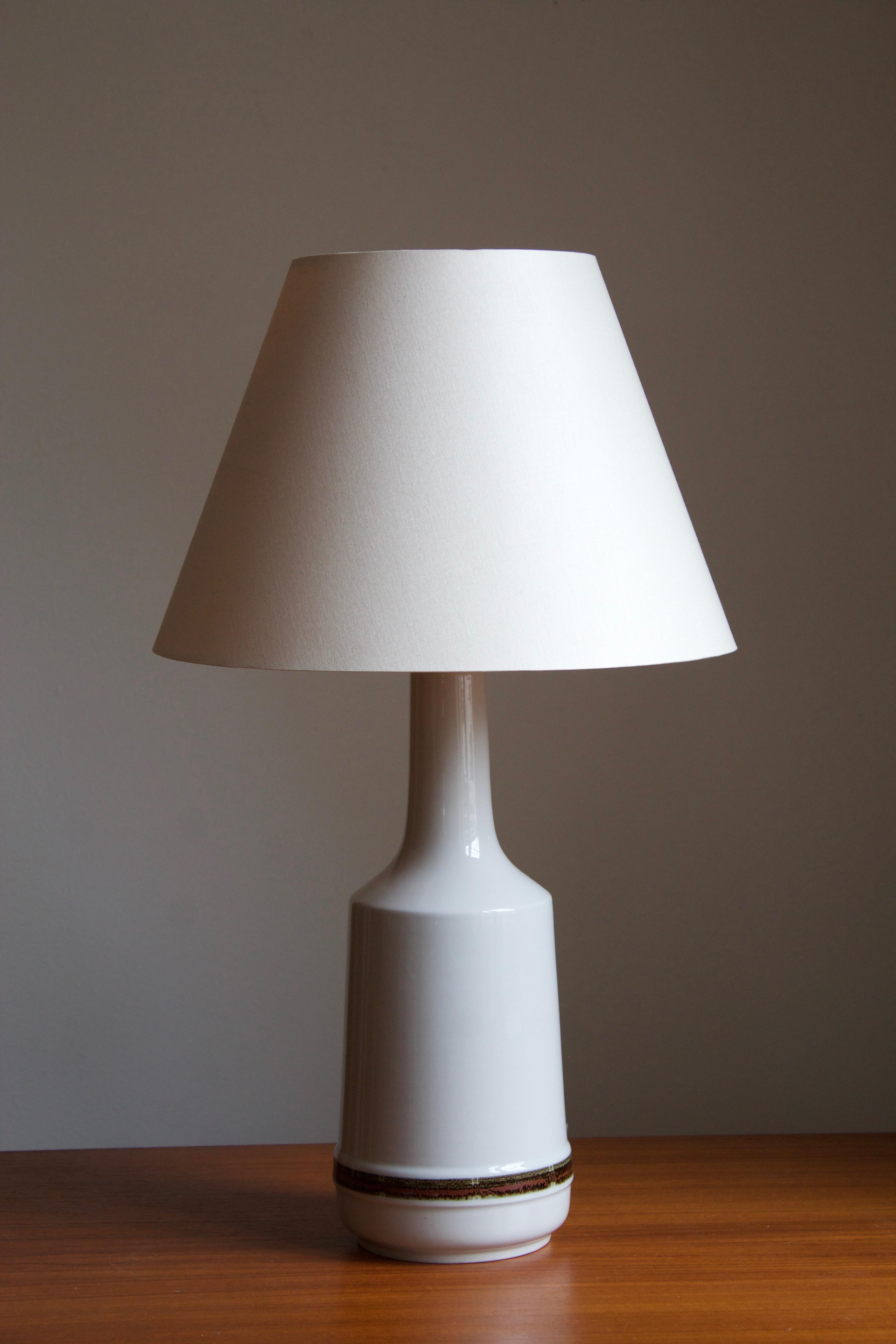 A table lamp, designed and produced by Desiree Stentøj, Denmark, 1960s. Stamped. Sold without lampshade.

Other designers of the period include Arne Bang, Axel Salto, Wilhelm Kåge, and Kähler.