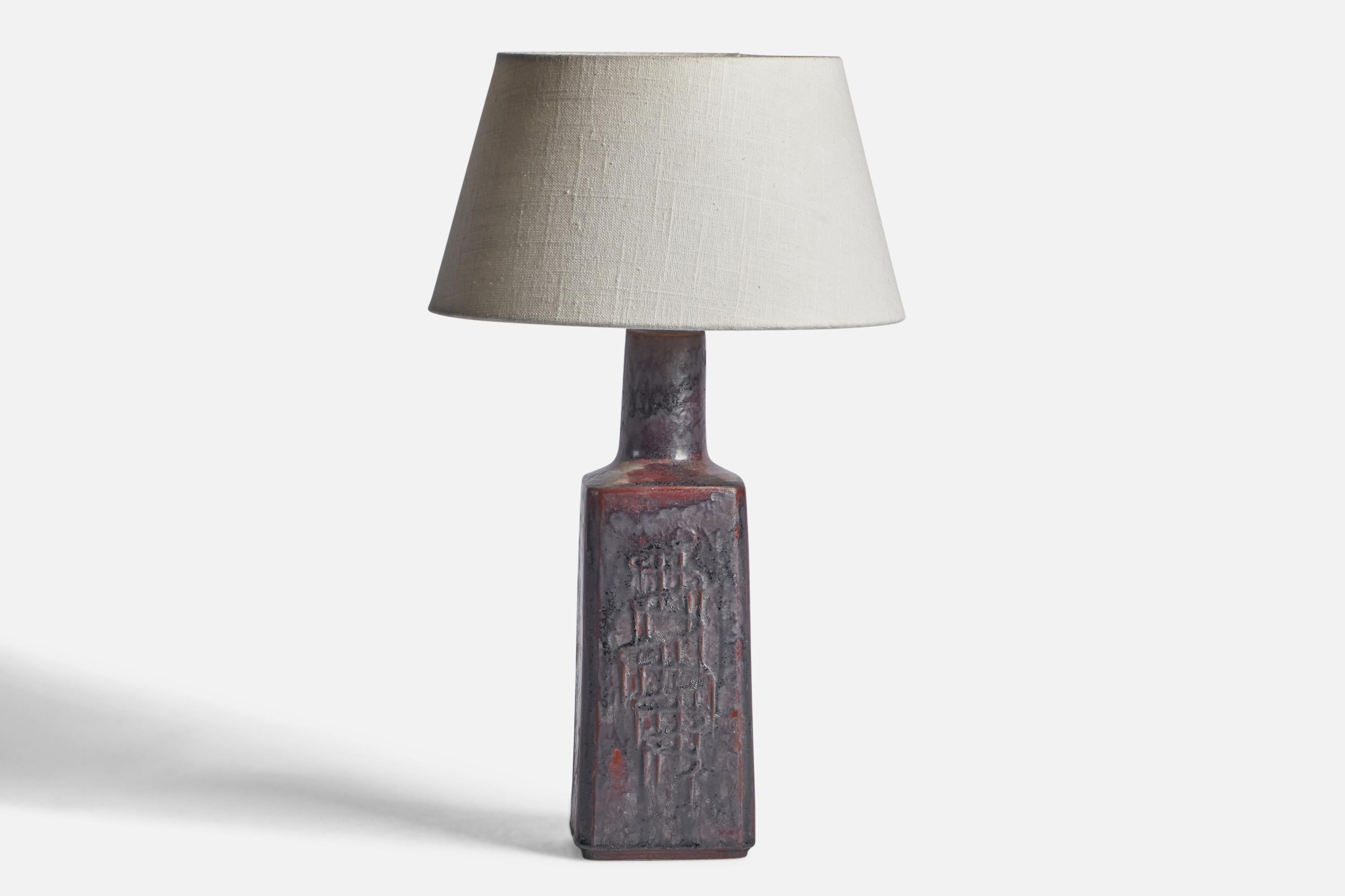 A black and red-glazed stoneware table lamp designed and produced by Desiree, Denmark, c. 1960s.

Dimensions of Lamp (inches): 14” H x 4” Diameter
Dimensions of Shade (inches): 7” Top Diameter x 10” Bottom Diameter x 5.5” H 
Dimensions of Lamp with