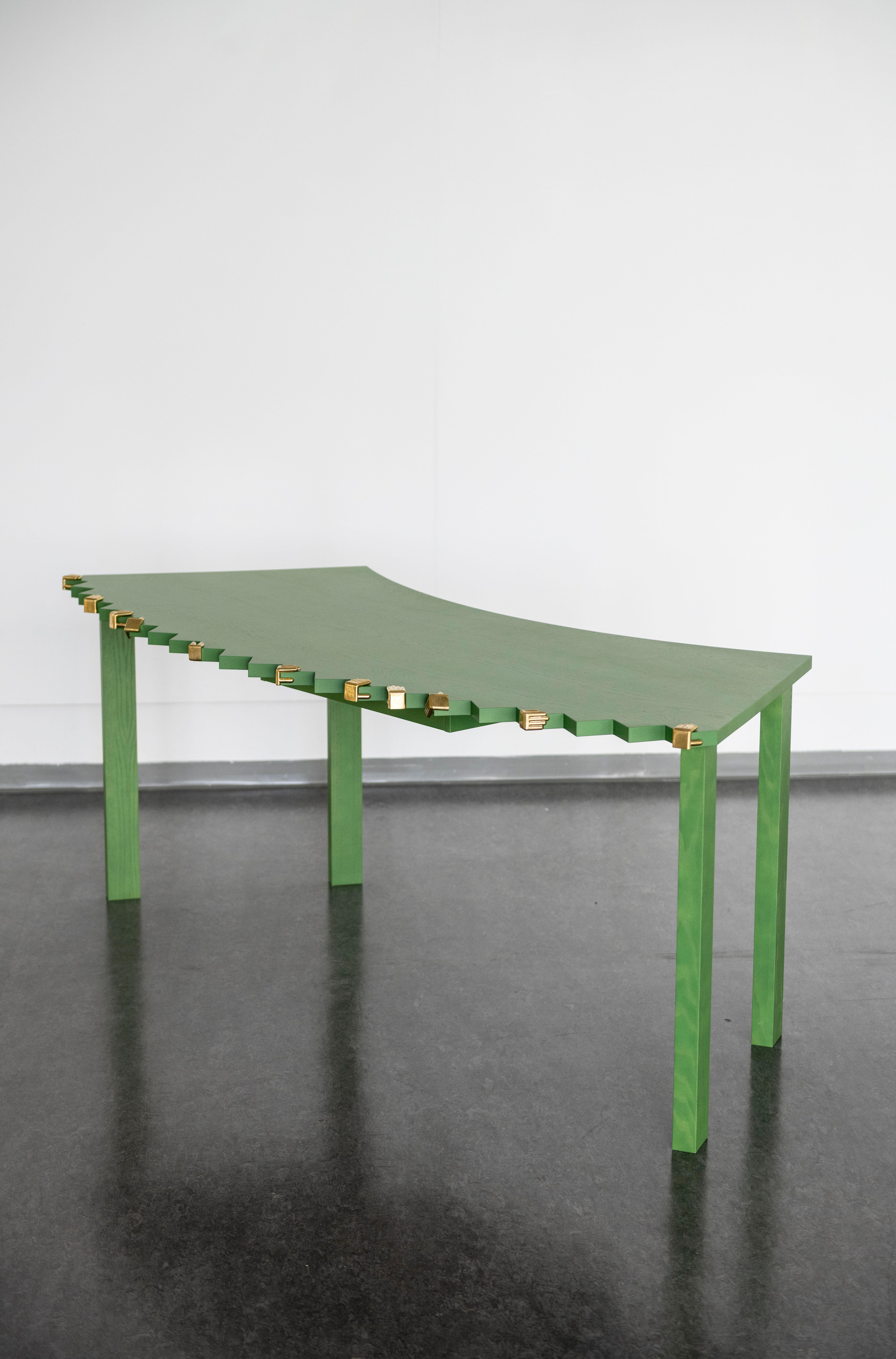 
„All Hands On Desk II“ desk with 12 hands, 2024
Johanna Pichlbauer, Clemens Schmidberger

Size 1928 x 855 x 746 mm
Solid Ash Wood, stained (RAL 6017), mat lacquered 
12 Corner Pieces by Johanna Pichlbauer, cast brass metal (cast by Paul