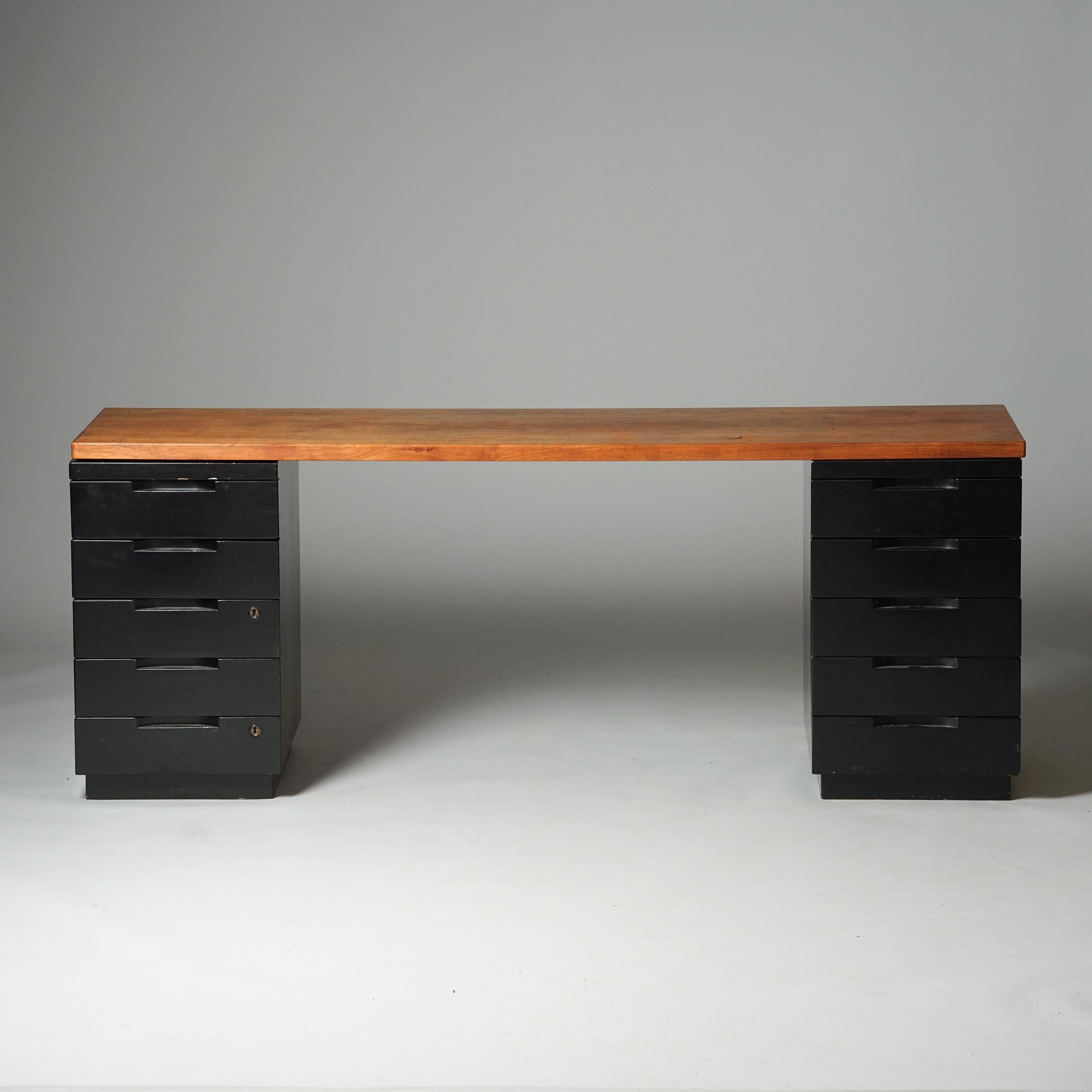 Desk, design Alvar Aalto, manufactured by Artek, 1950/1960s. Teak table top with painted wood drawers. Good vintage condition, patina and wear consistent with age and use. 

Alvar Aalto (1898-1976) is probably the most famous Finnish architect and