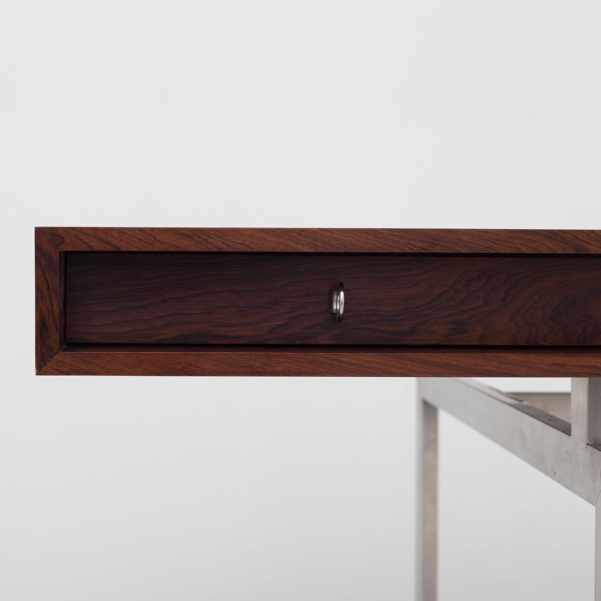 Desk in rosewood on steel frame with central locking. Reissued edition by Hothouse Design, around 15 pieces made in 2007.