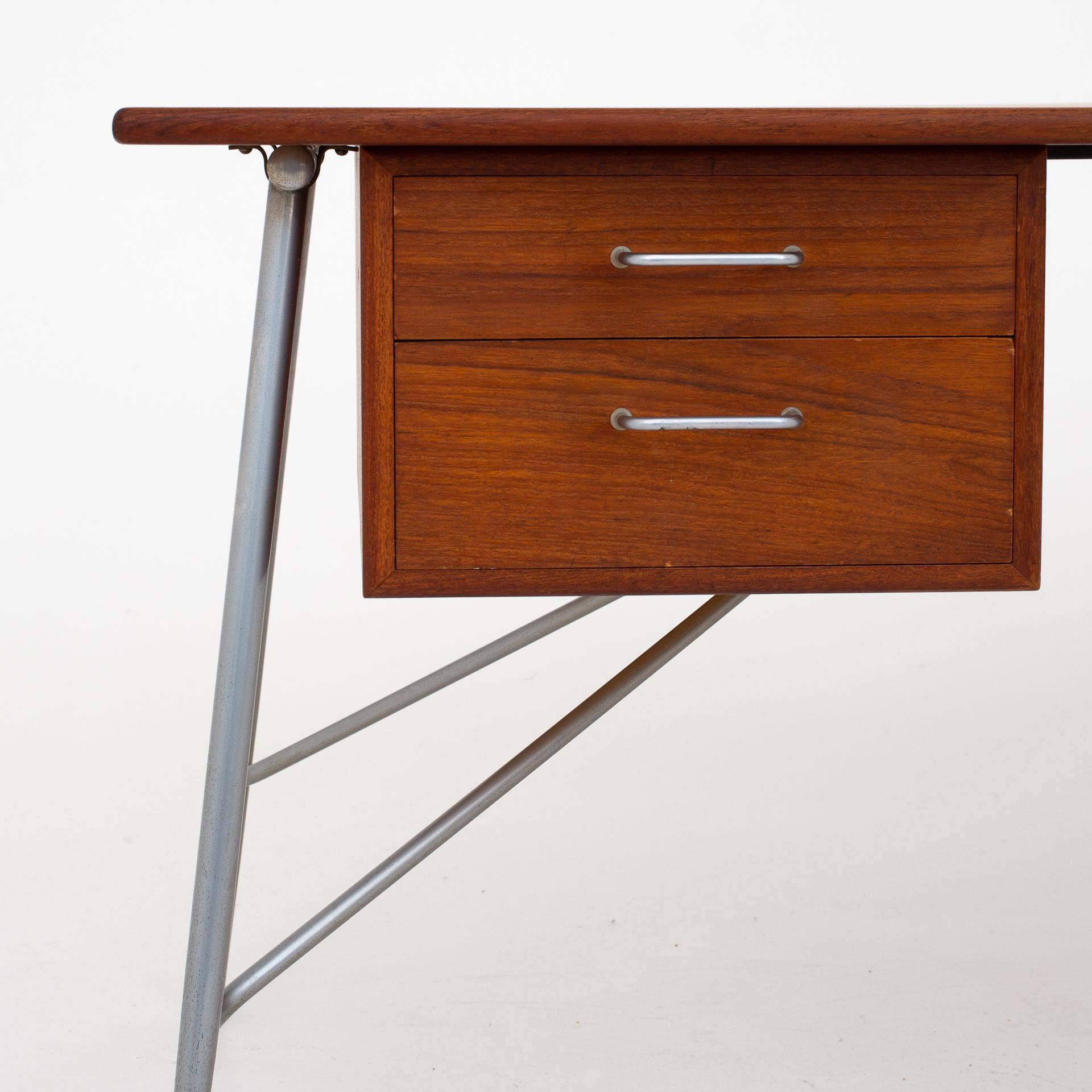 SM 202 - desk in teak on steel frame with four drawers. Designed in 1953. Maker Søborg Møbler.