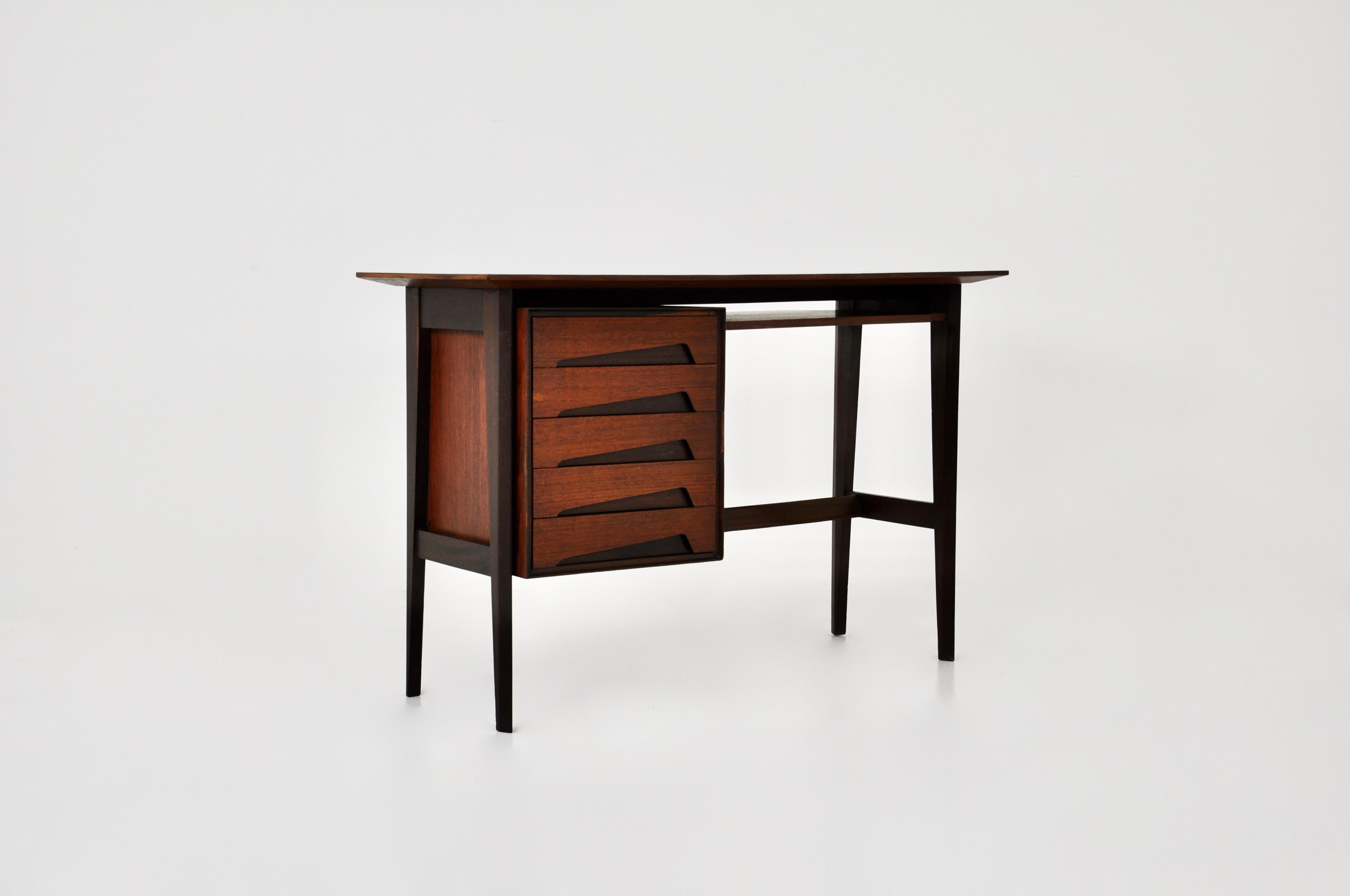 Wooden desk with 5 drawers designed by Edmondo Palutari. Wear due to age and age of the desk.