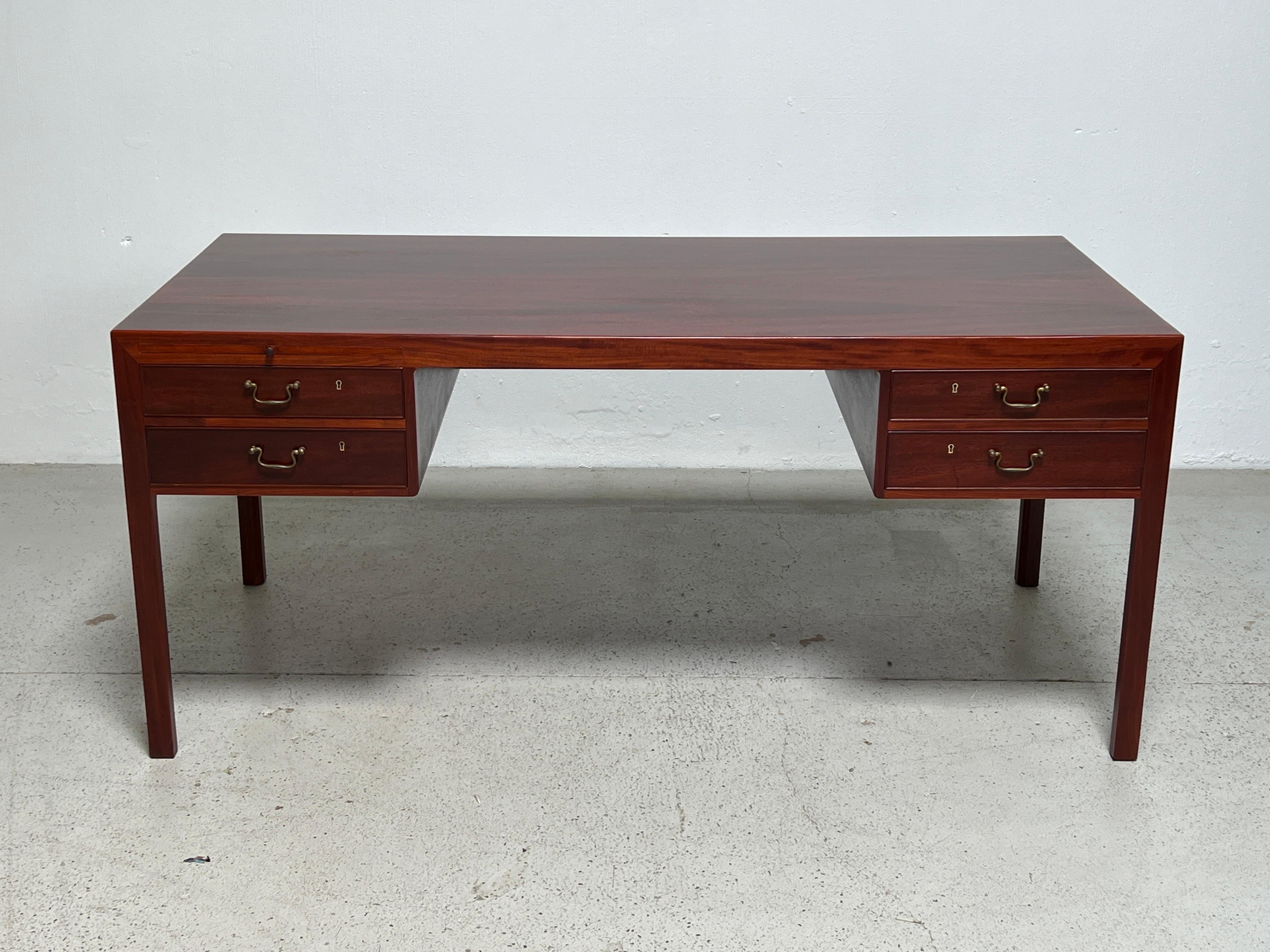 An elegant mahogany desk designed by Ejner Larsen & Aksel Bent Madsen for Willy Beck. 