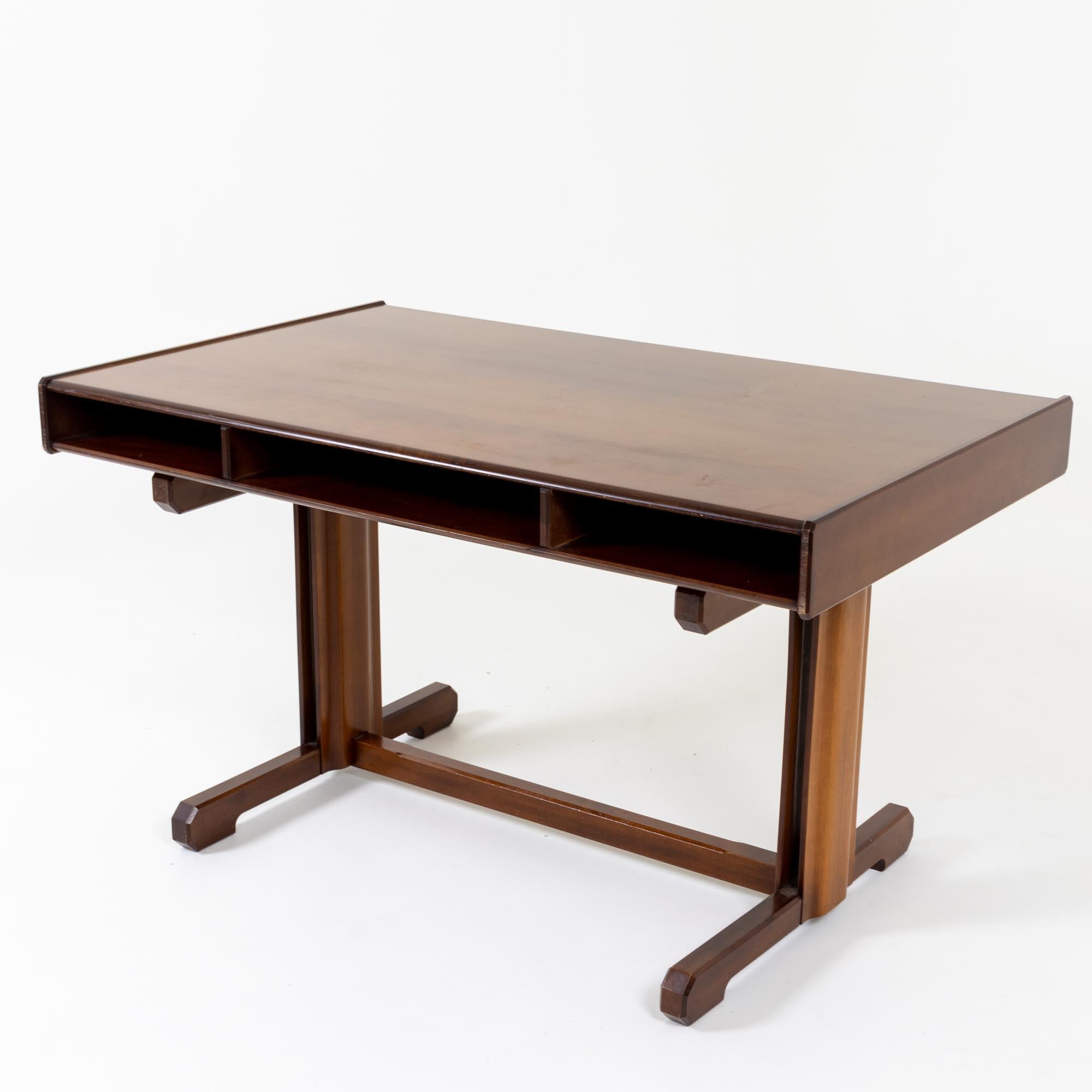 Dark brown desk with two drawers designed by Gianfranco Frattini in the 1950s. The desk stands on a solid base with H-shaped bracing. The rectangular tabletop features two drawers with round knobs and a central storage compartment on the front.