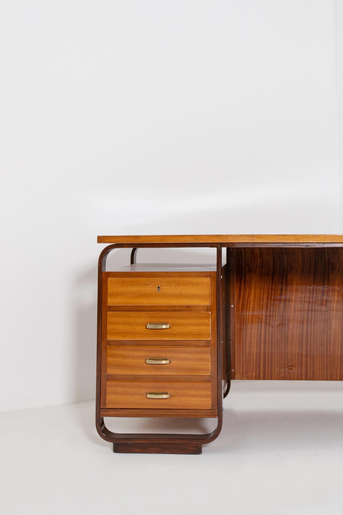 Imposing desk by Giuseppe Pagano, 1940. Scrivania designed for the Bocconi University in Milan Wood. Execution Maggioni, Varedo, ca. 1940. We notice two types of essences for its realization. The peculiarity of the desk are its side drawers framed