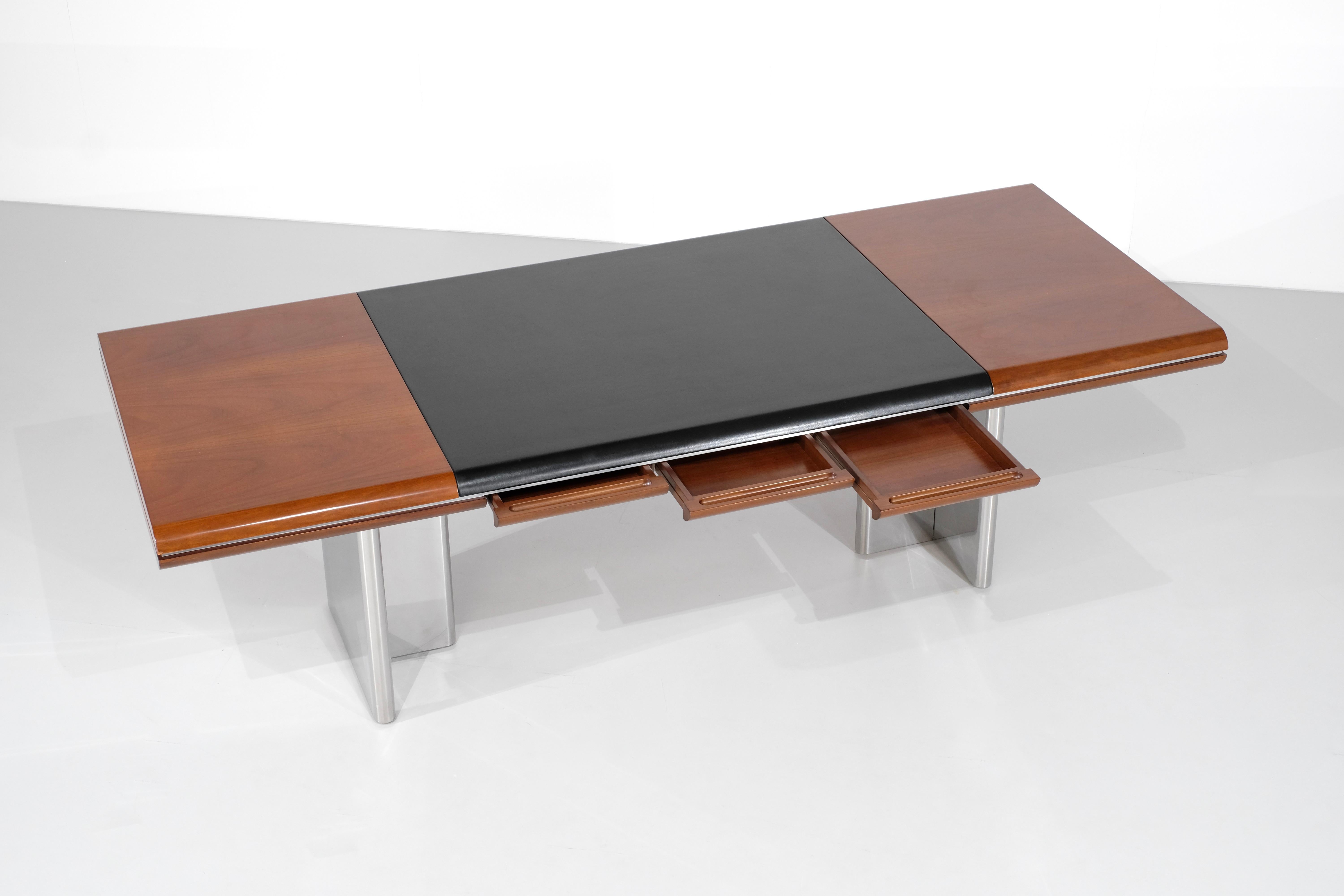 Description
Executive Desk In wood with black leather on the top with three drawers posed on two T-shaped legs in chromed metal.

Scratches on the varnish visible at an angle under a strong light.

Designed by Hans von Klier for Skipper, Italy