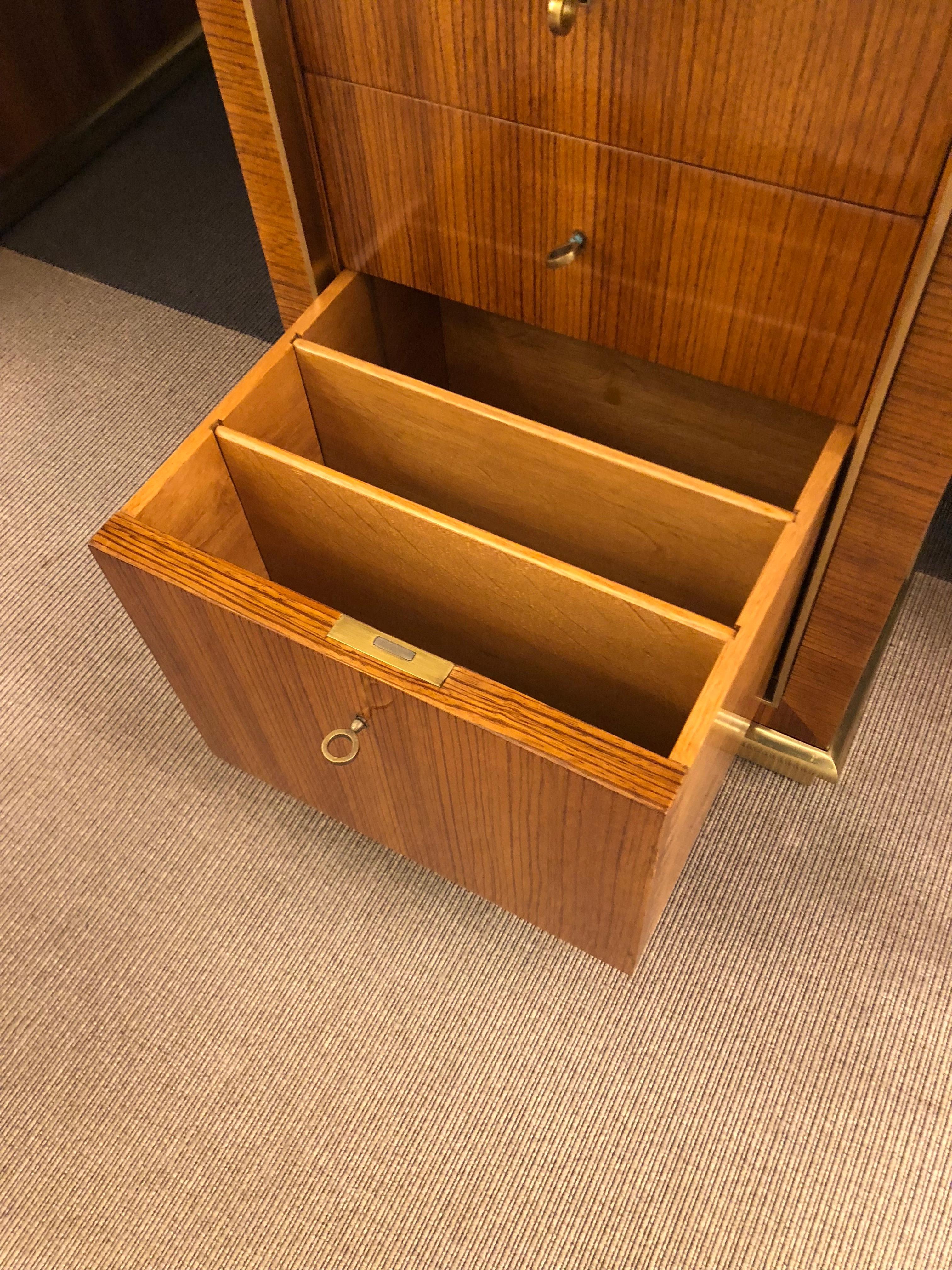 Rosewood desk with a bronze framed glass sitting atop a wooden surface and two cabinets, each featuring two drawers and a customizable filing cabinet, surrounded by a bronze frame. Designed by Royere and made by Maison Gouffe, tag intact.

OUR