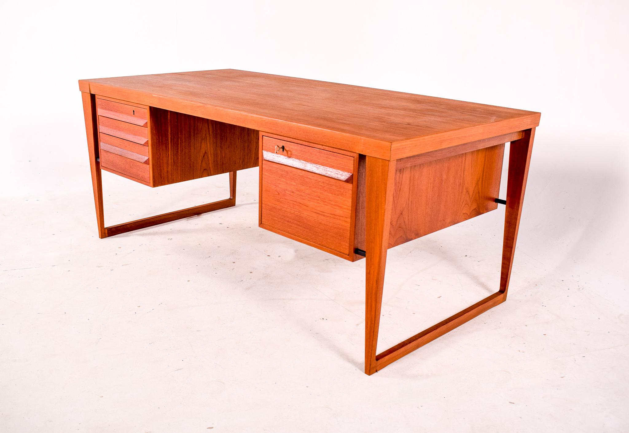 Kai Kristiansen design this large desk in 1950s for Feldballe Mobelfabrik. Model n. 70 in teak wood. This desk have six drawers on the front and two doors on the backside. Very quality danish desk with nice design.