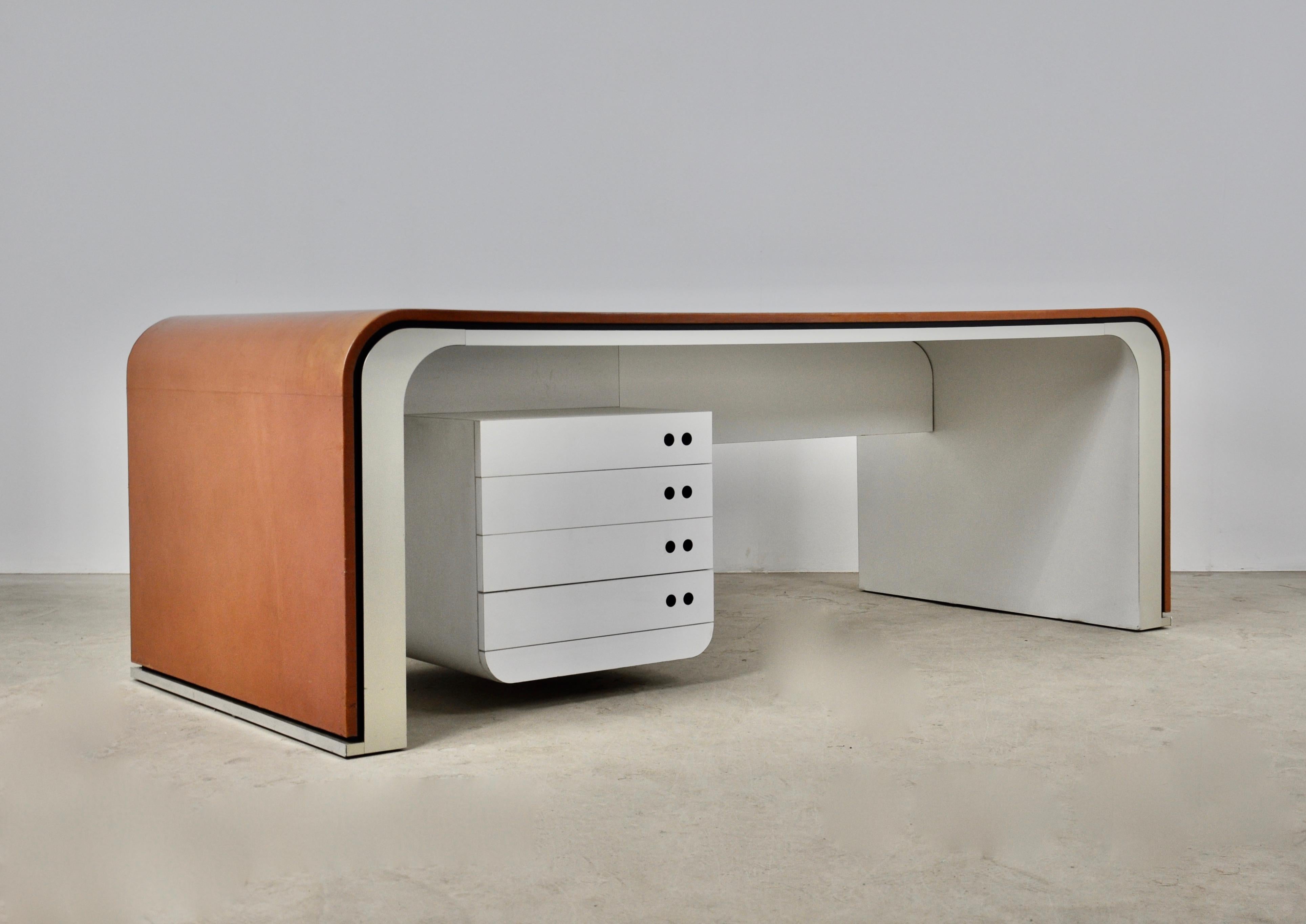 Leather, aluminum and bakelite desk. Wear on the aluminum on the back of the desk (see picture).