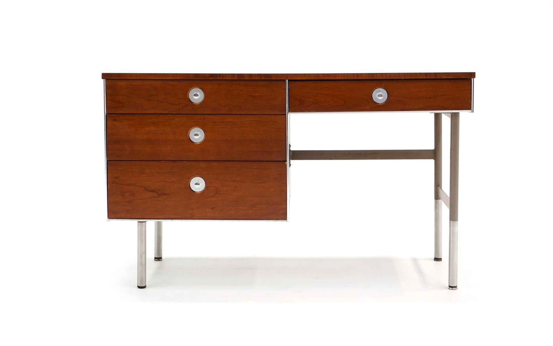 1960a Raymond Loewy for Rom Hill small desk in very good, ready to use all original condition. Walnut case with steel frame and aluminum trim and pulls. Single pedestal with three drawers and single drawer above the knee opening. Original laminate