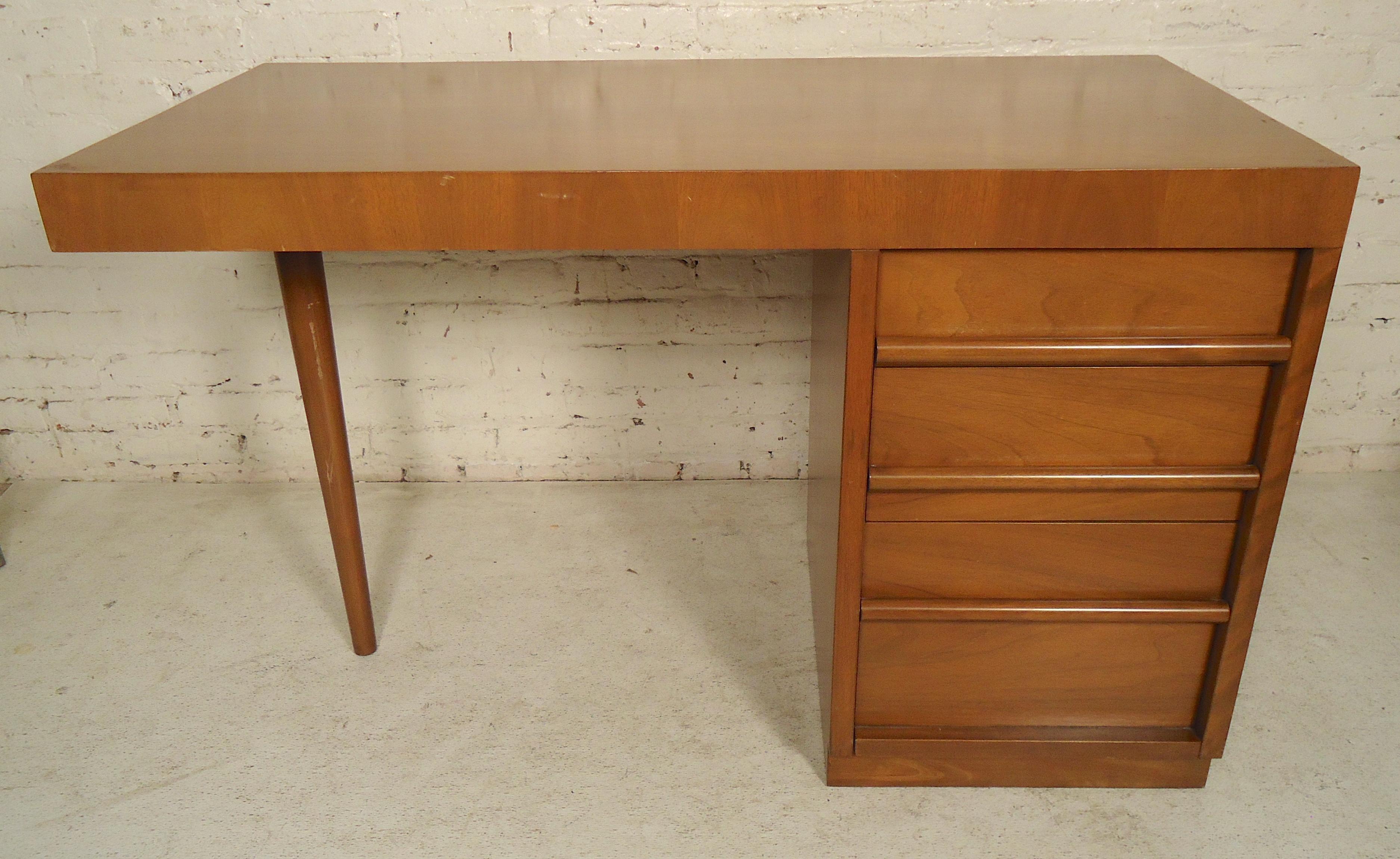 Mid-Century Modern desk with right side drawers and a tapered leg.
(Please confirm item location - NY or NJ - with dealer).
  