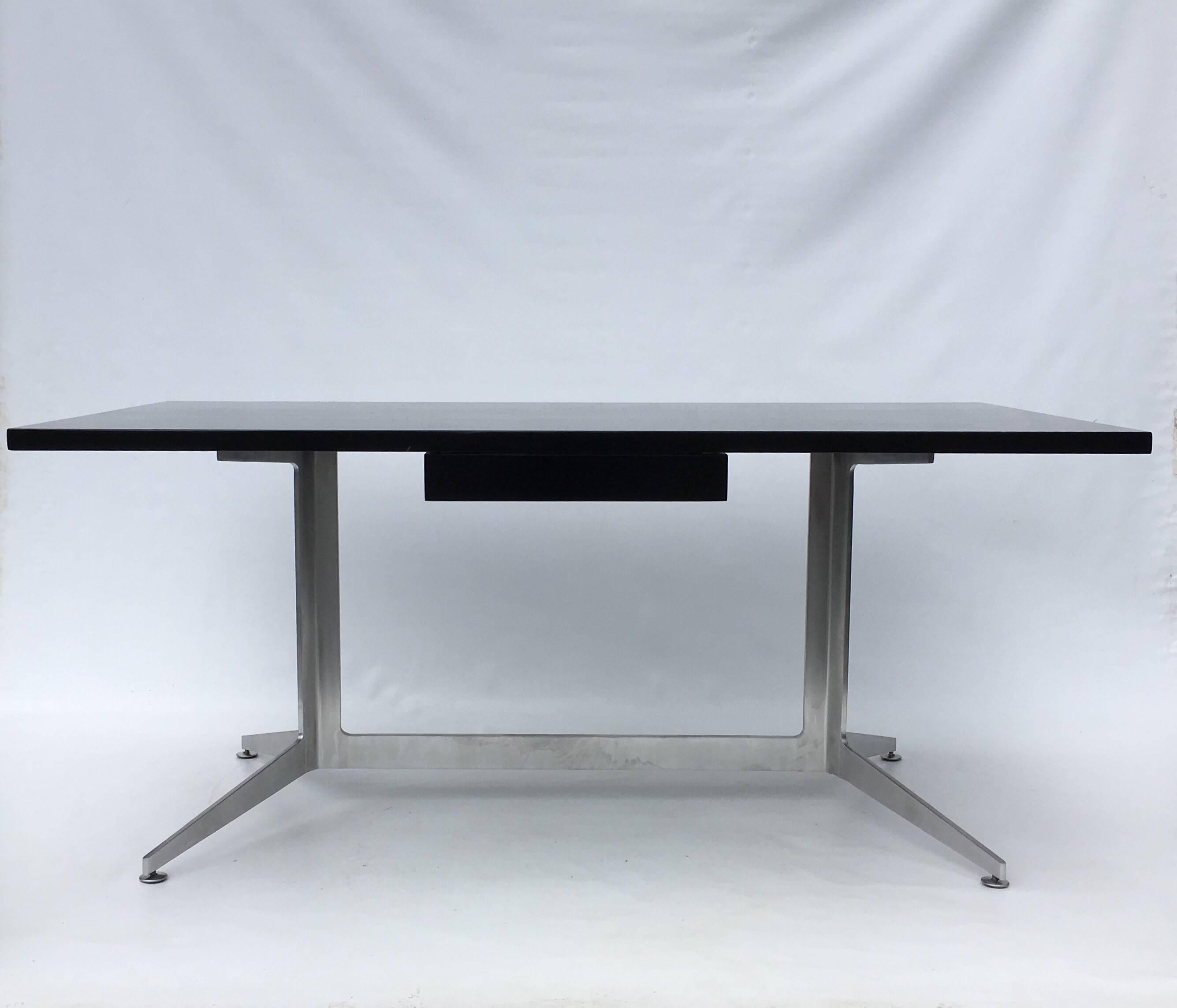 Desk by Ward Bennett, black painted wooden top with drawer sitting on a aluminium base.