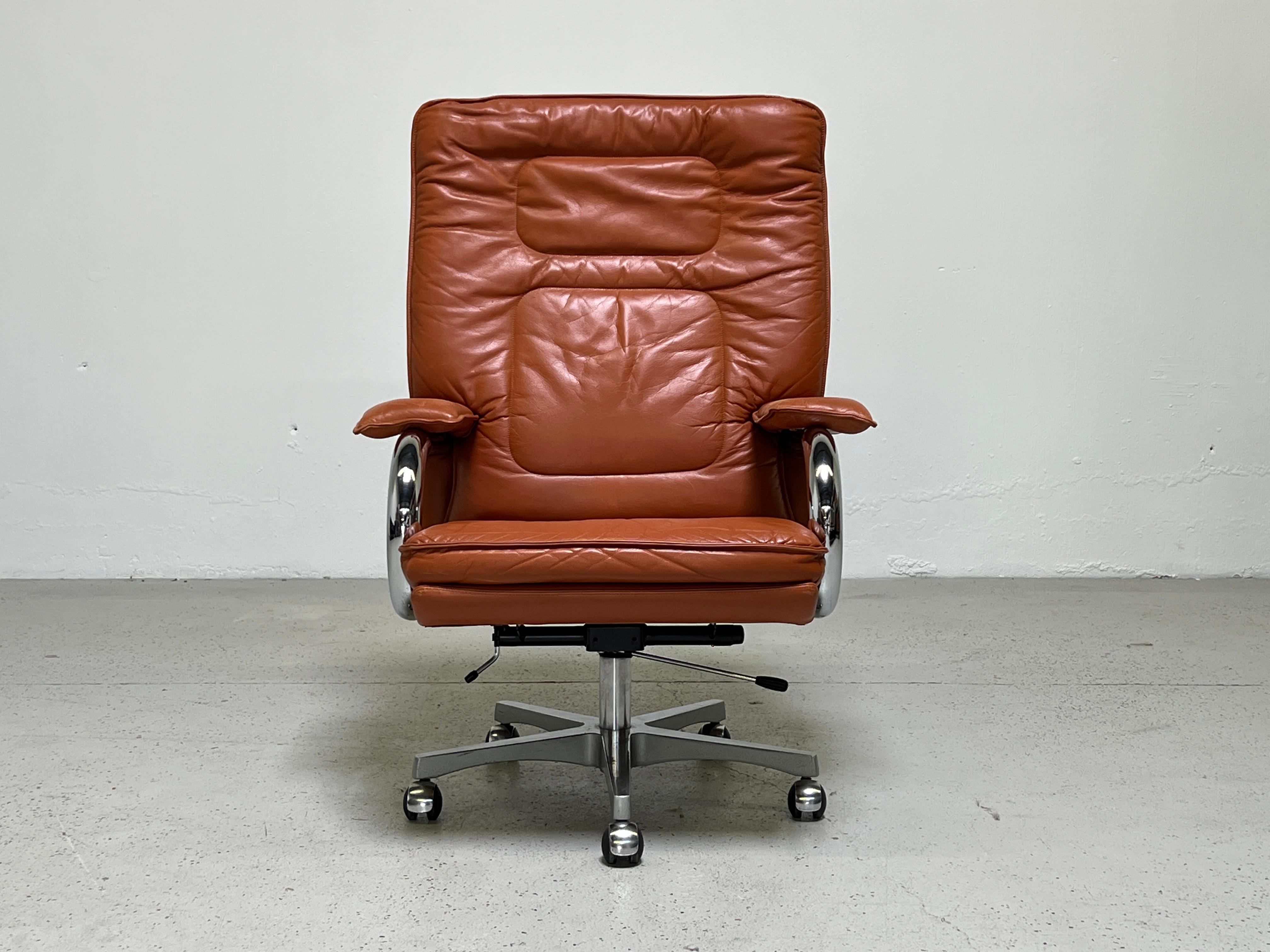A large scale executive desk chair in leather designed by Guido Faleschini for i4Mariani and sold through Pace. Extremely comfortable with patinated leather and adjustable hight / tilt.  Ten matching chairs available. 