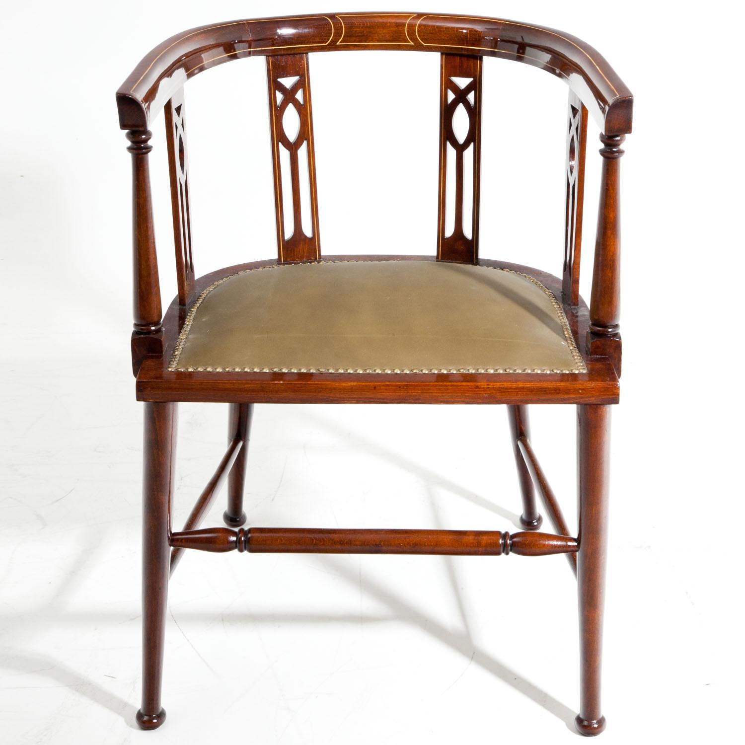 English desk chair standing on conical legs with turned stretcheres between them. The curved backrest is supported by decorative pierced slats, both of which are decorated with Fine thread inlays. The seat is slightly cushioned and was reupholstered