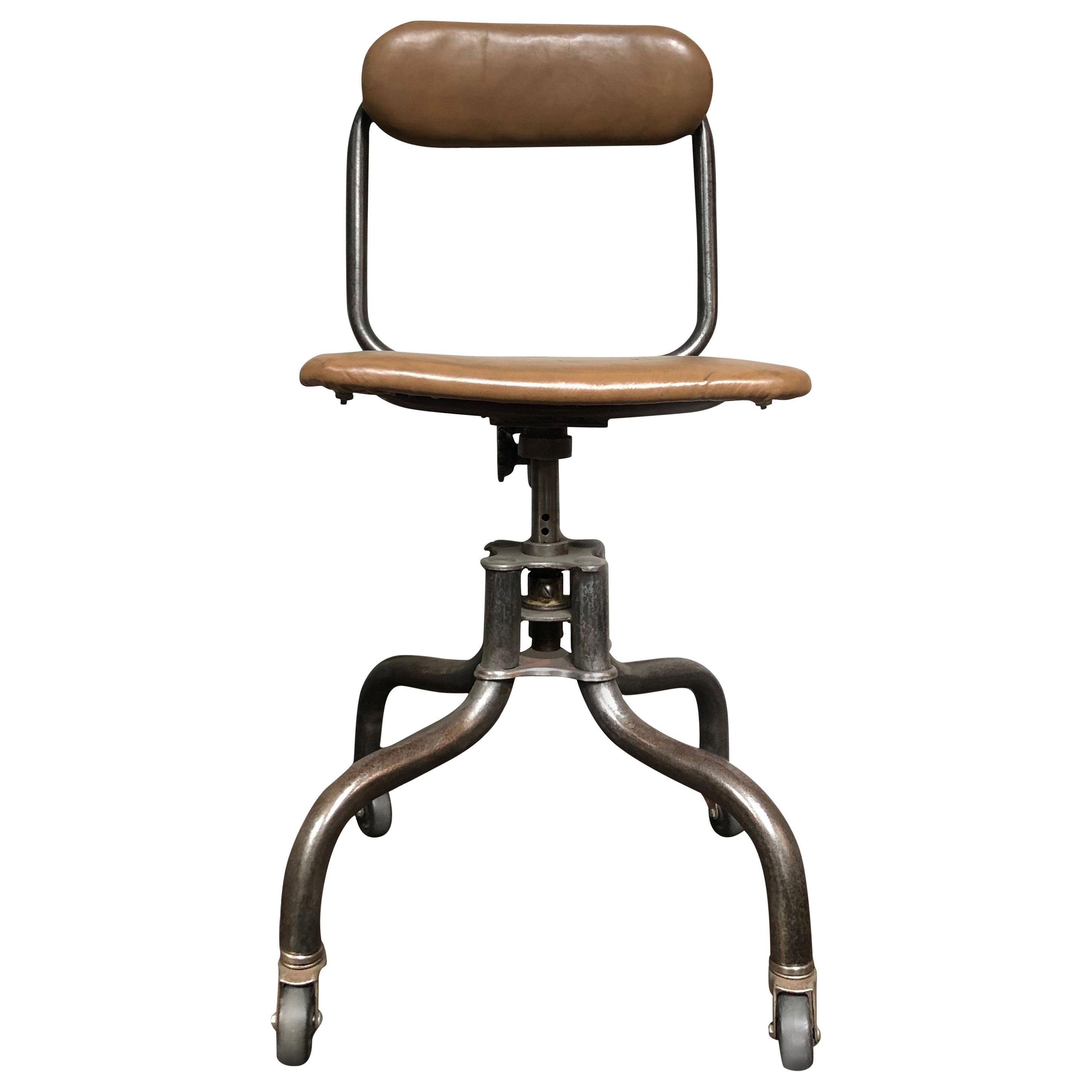 Adjustable swivel metal desk chair on wheels with leather seat and back from the 1940s. 
