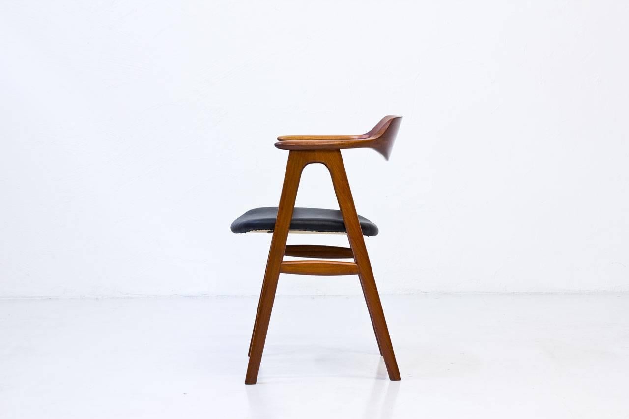 Desk chair by Danish designer Erik Kierkegaard, manufactured in Denmark by Høng Stolefabrik during the 1950s. Made from solid teak with black leather upholstery seat.