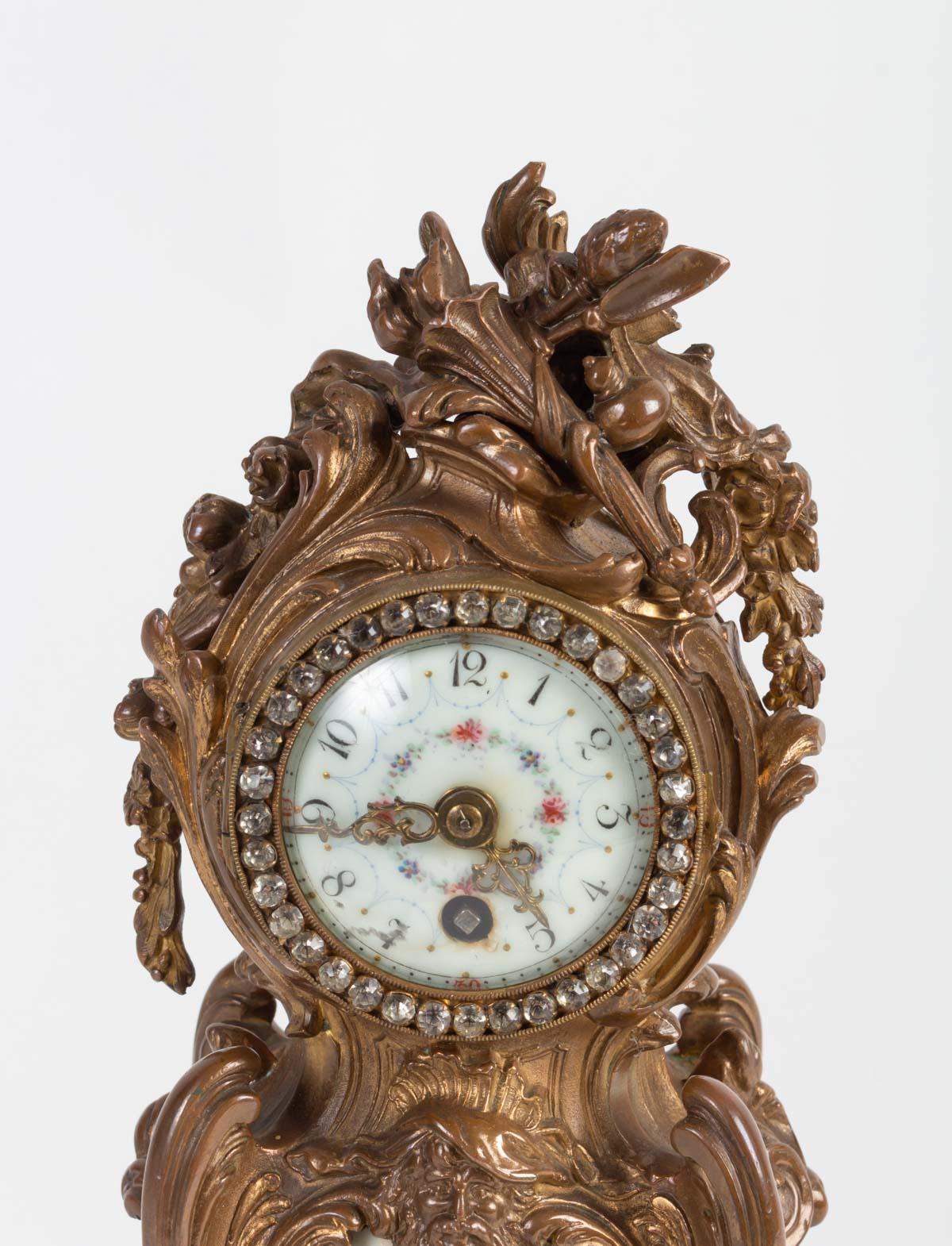 Desk clock in regulation and porcelain, enameled dial, strass, 19th century.

Measures: H 30 cm, L 12 cm, D 10 cm.