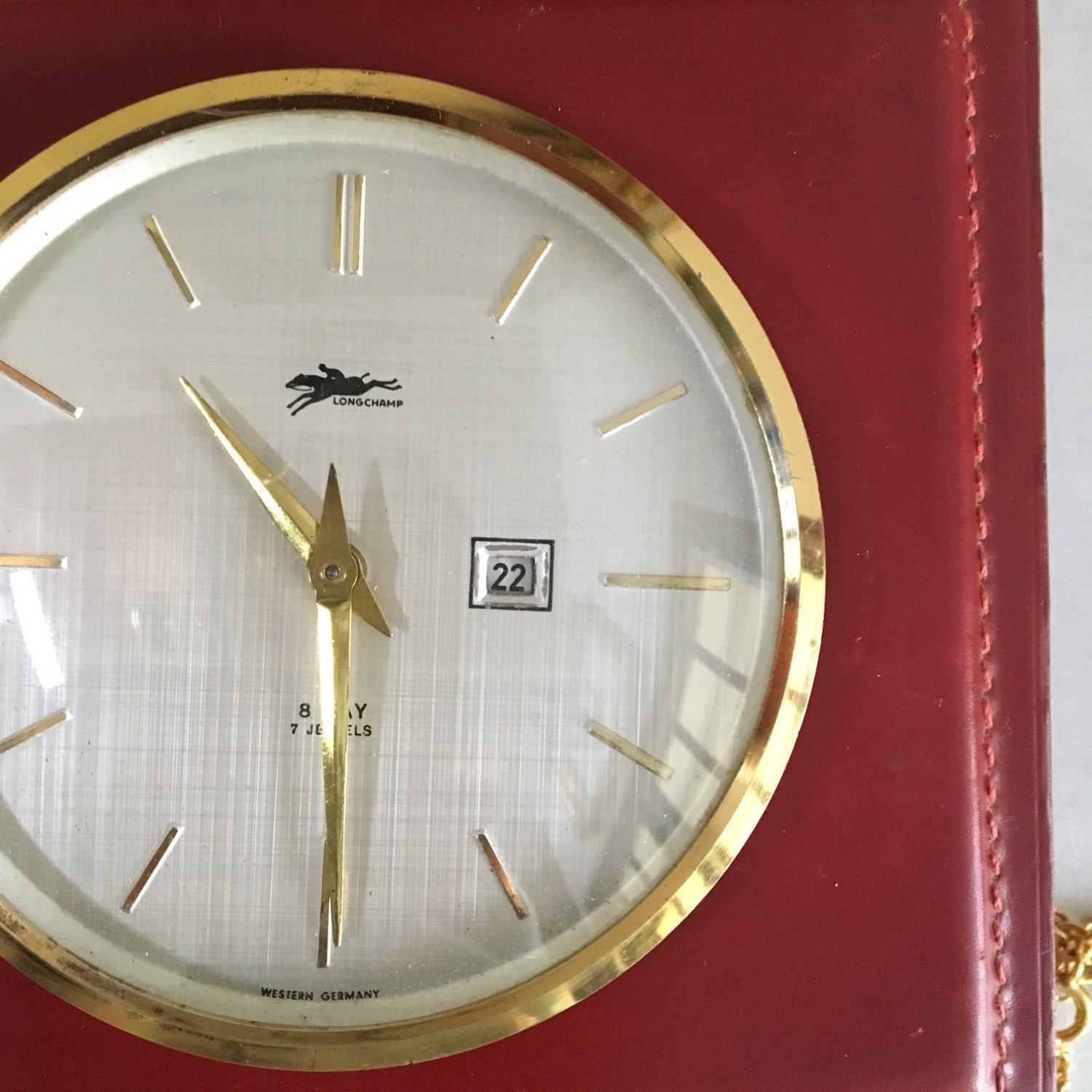 Here is a nice table clock with box of the brand Longchamp. Can be use as jewelry box for women, or desk box for men.

In wood covered with burgundy leather and brass dial.

The clock is 8 days and 7 jewels.

Nice gift to offer!

This box