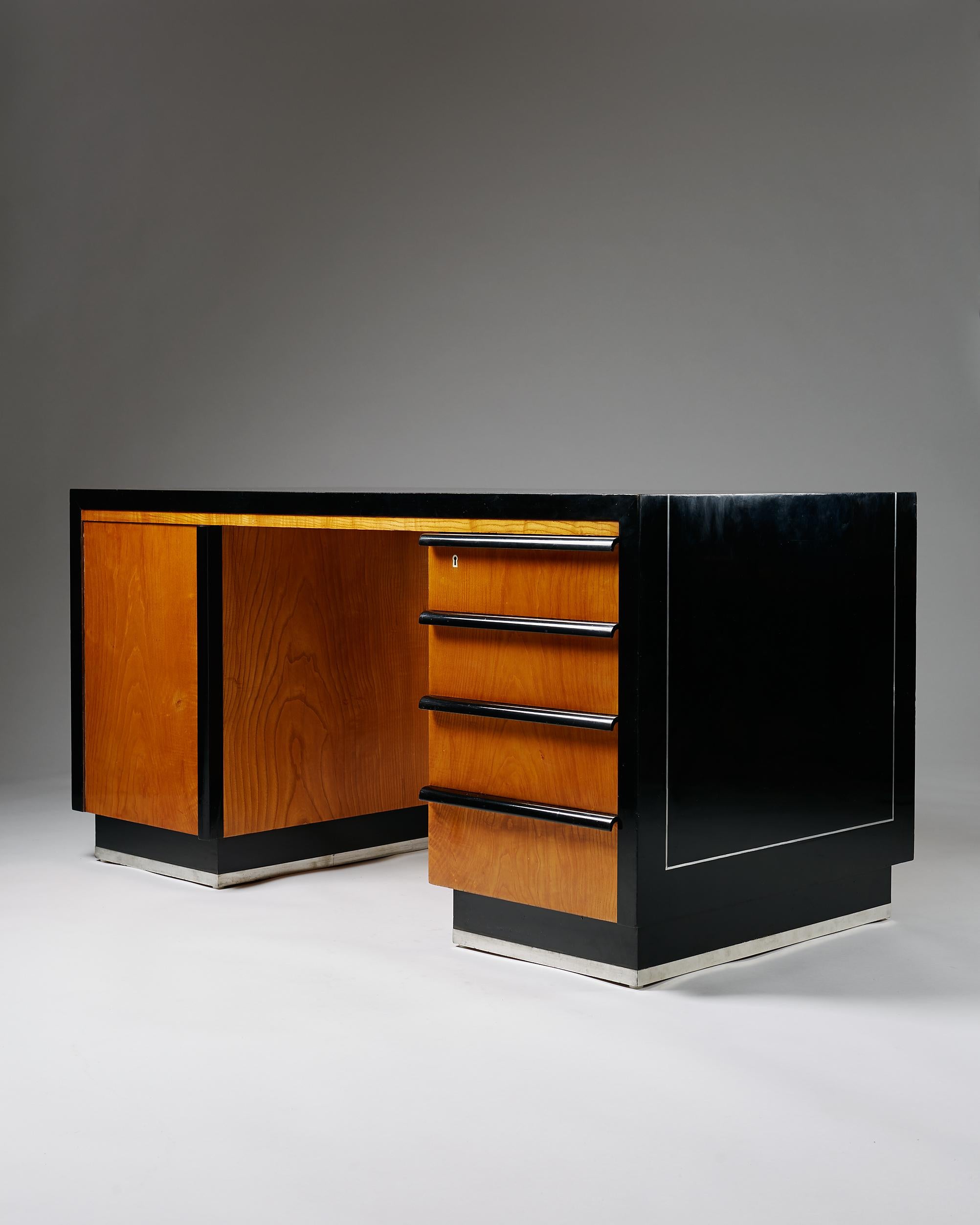 Desk designed by Alvar Andersson for Hyresgästföreningen, retailed by G.A. Berg
Sweden. 1930s.

Black lacquered birch, elm and pewter inlay.

Dimensions:
H: 75 cm/ 29 1/2''
L: 150 cm/ 4' 11''
D: 75 cm/ 2' 6''

Provenance: private collection, Sweden.