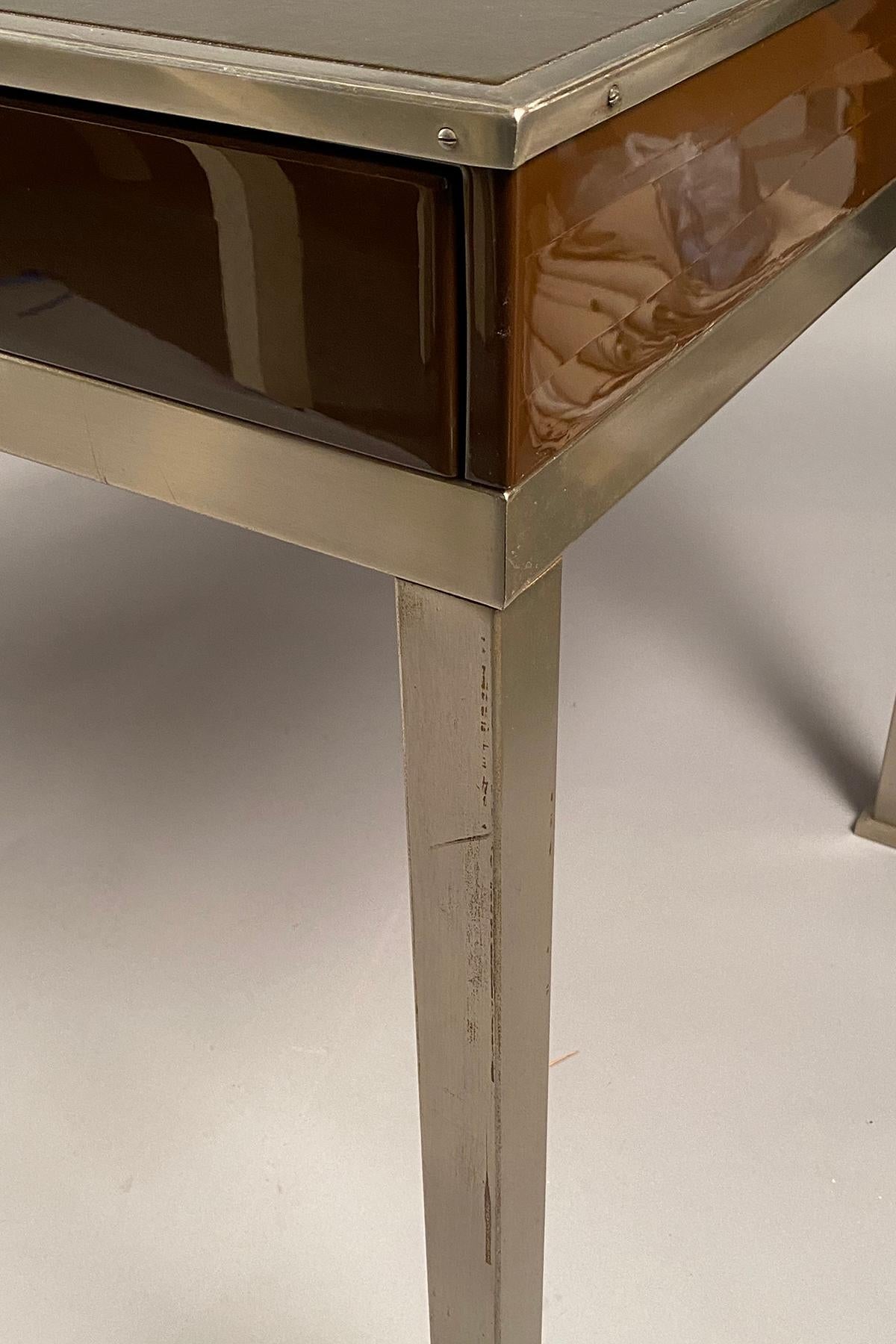 Brown lacquer and chrome table structure with three drawers, supporting a brown leather top. Original condition, the lacquer has slight cracks, but no losses.
   