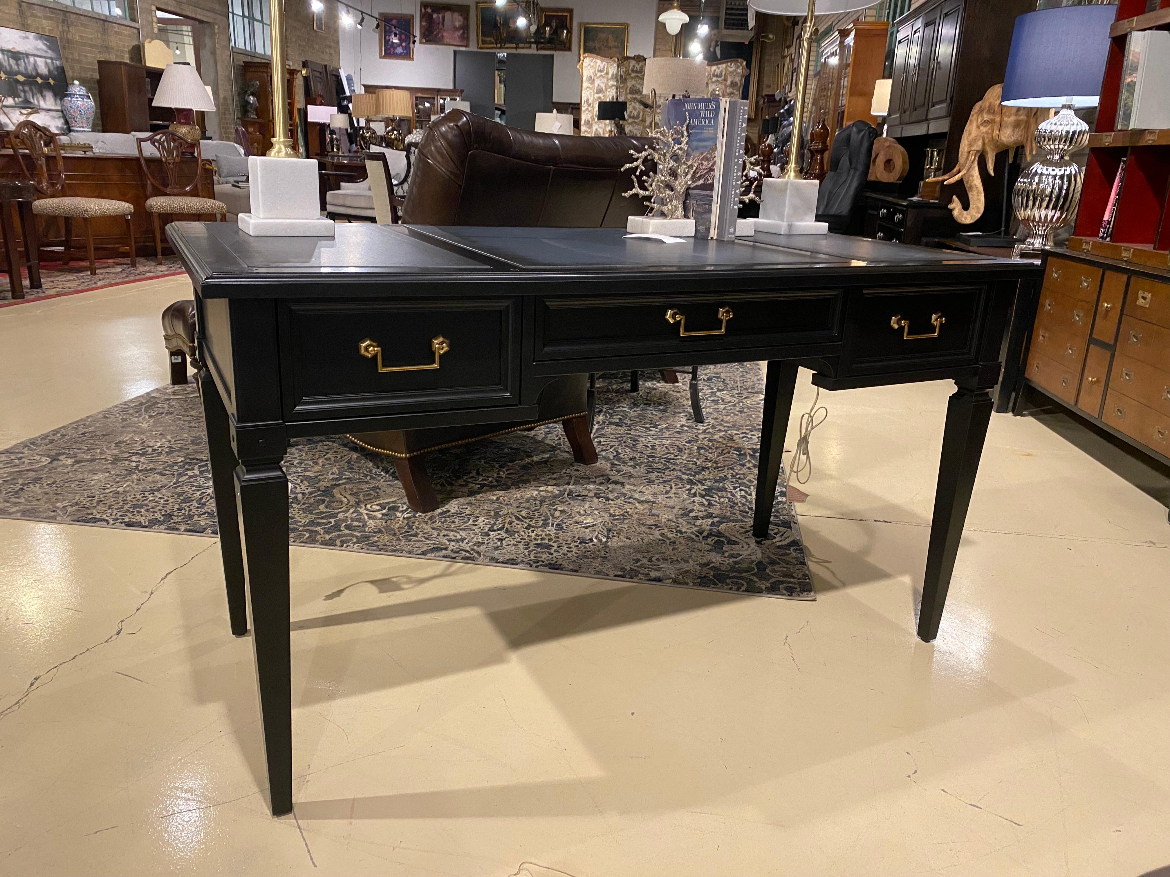 We present a beautifully finished desk made in Italy by Selva in cherry wood, with a leather writing surface. This item has been recently re-stained by our expert team in a black lacquer and accented with a grey leather writing surface, which also