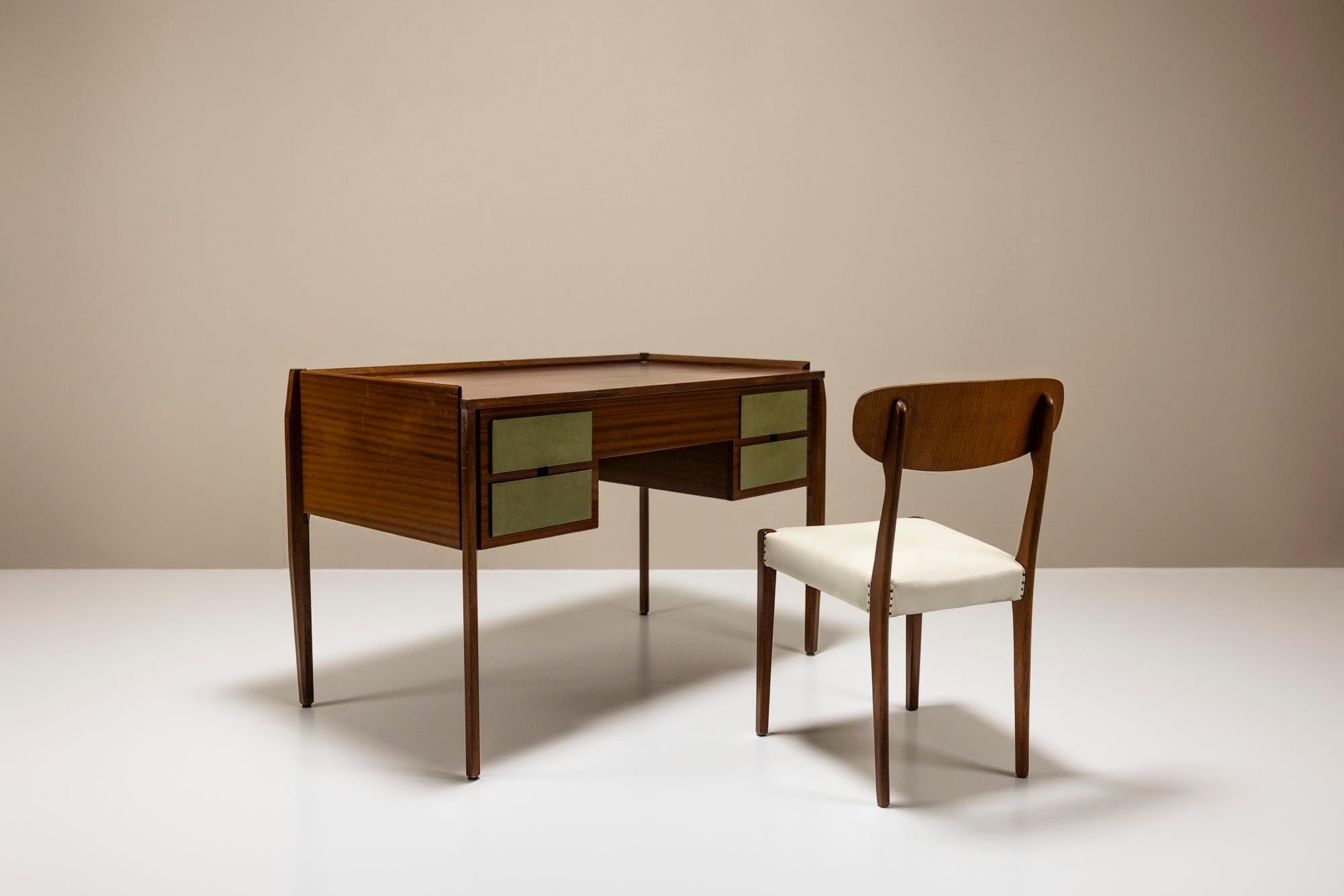 This desk is unassuming yet quietly captivating. Attributed to the renowned designer Gio Ponti, its elegant tapered legs draw the eye effortlessly. Veneered in rich mahogany, the desk exudes warmth and character, its surface adorned with a gentle
