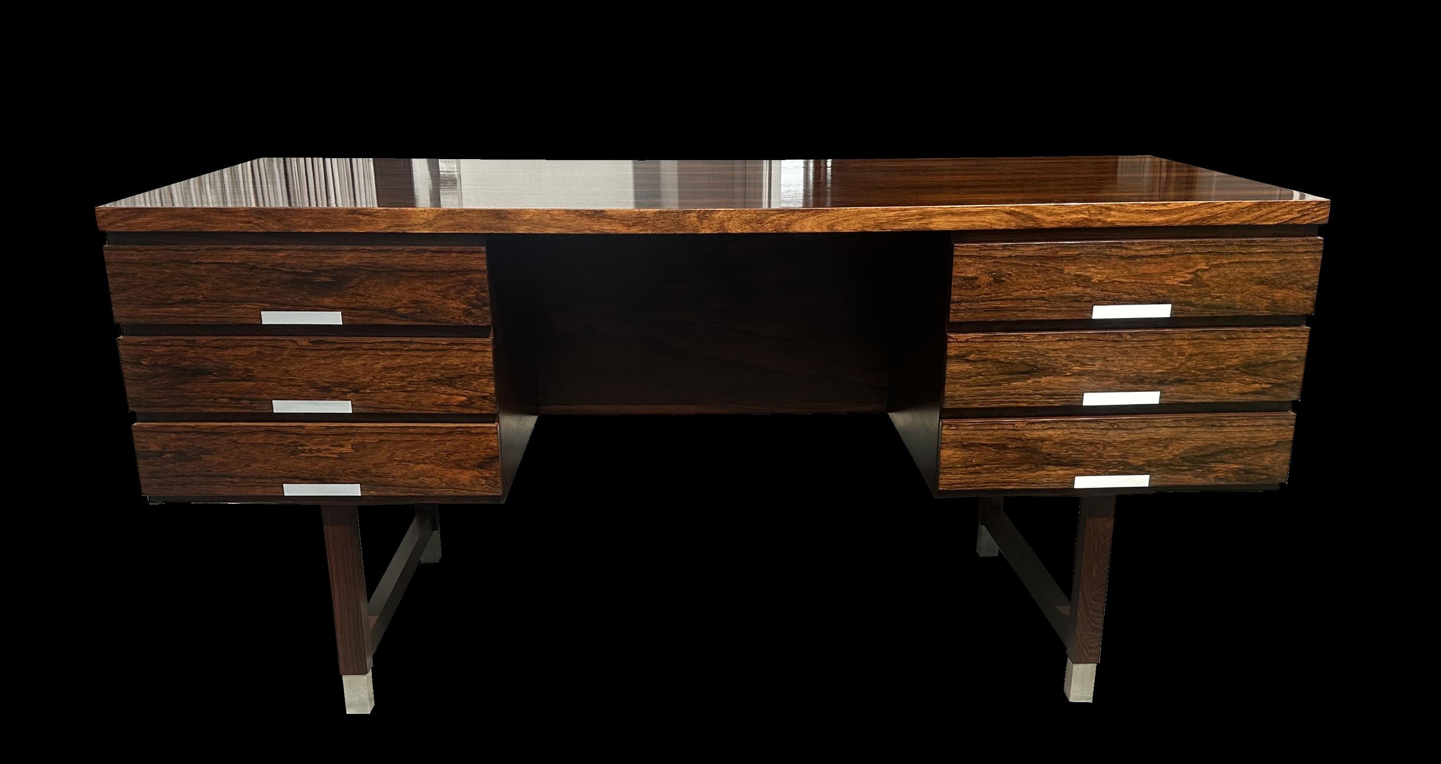 This is a very nice desk by Danish designer Kai Kristiansen, in Santos Rosewood (Machaerium Scleroxylon a sustainable species not on endangered timber lists so no problem for import/export)
with Aluminium accents on the drawer pulls and feet