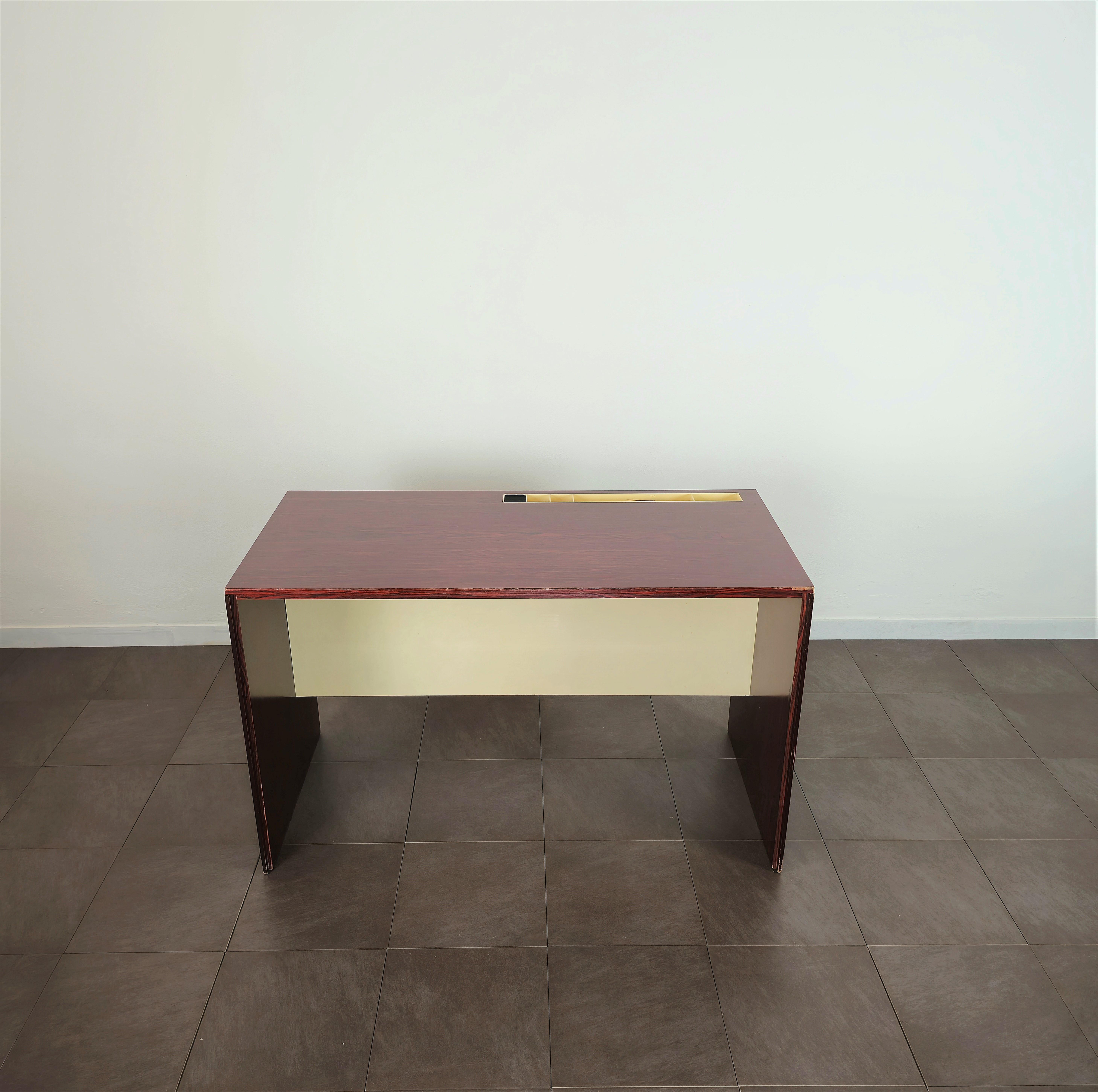 Rectangular desk made entirely of dark wood and enameled cream with plastic stationery compartment on the top. Made in Italy between the late 60s and early 70s.Exceptional for placement in a small space. Thanks to its dimensions.  Please watch the