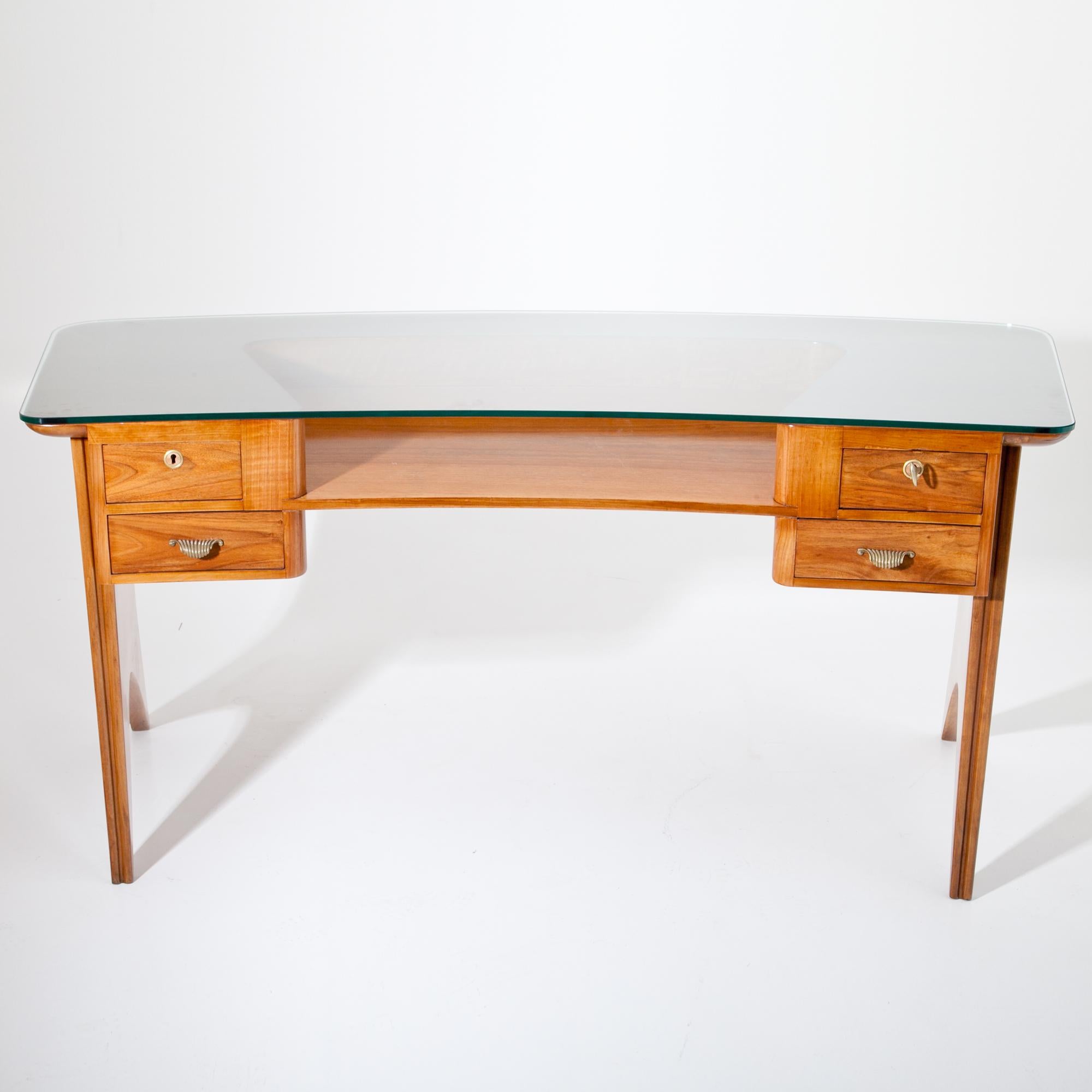 Slightly curved Italian desk, standing on tapered side panels. The desk has four drawers and one big shelf underneath the glass tabletop. The desk was professionally refurbished.