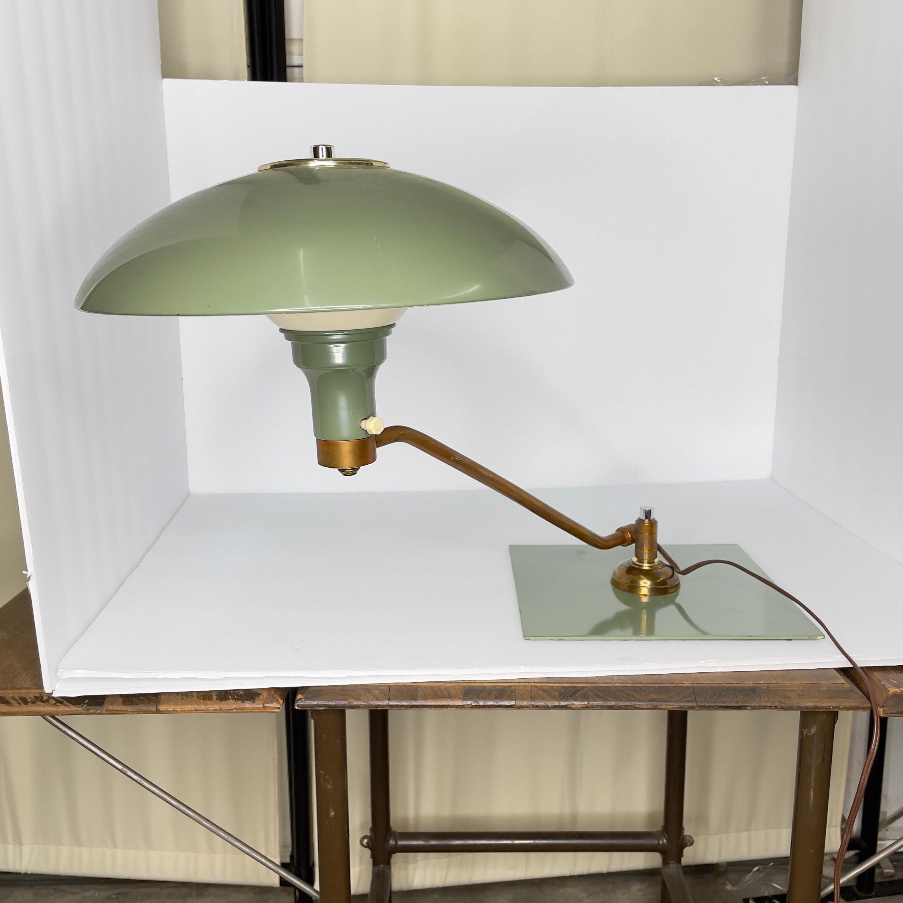 Here’s a cool lamp that can swing around where you need it to. Would be great for your desk. It is in the style of MG Wheeler’s “Sight Light” Saucer lamps. Appears to be green acrylic enamel paint over a heavy metal material. There is a weighted