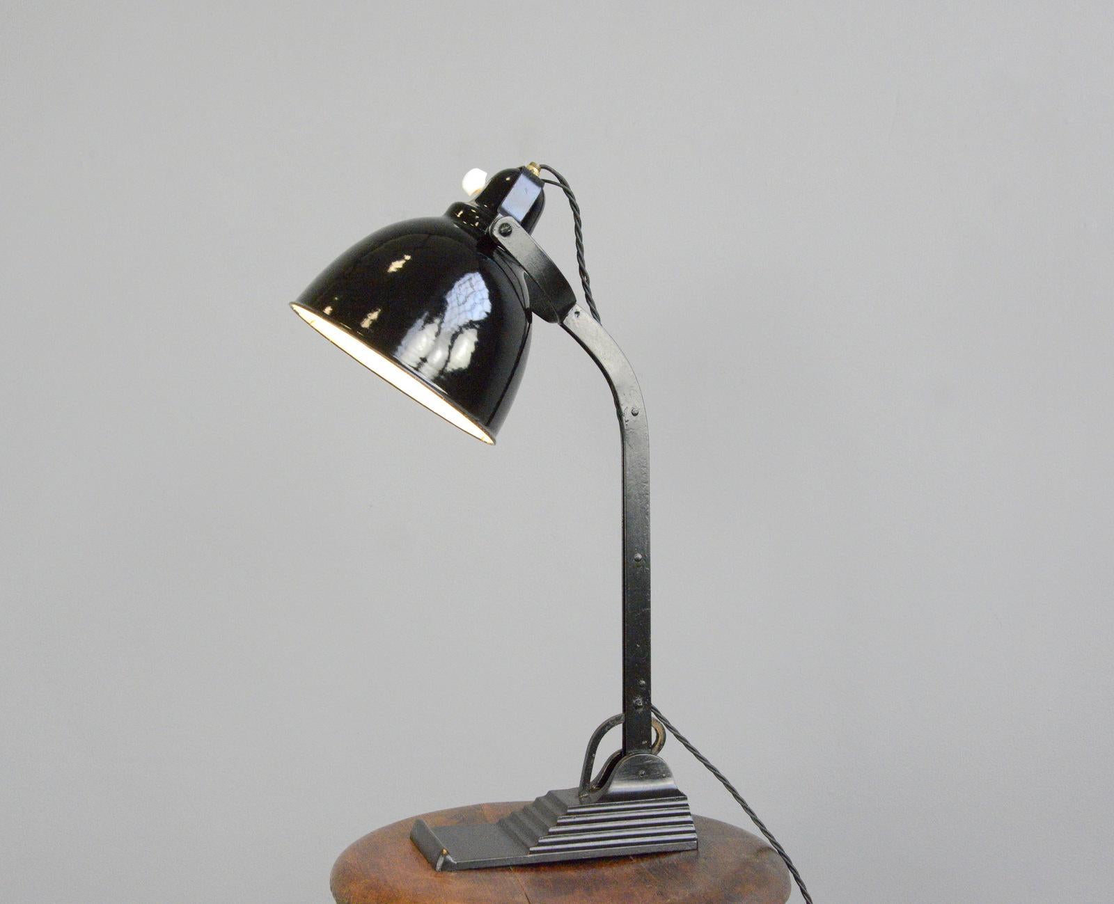 Desk lamp by Horax, circa 1930s

- Vitreous black enamel shade
- Stepped cast iron base
- Adjustable arm and shade
- Original porcelain On/Off switch on the shade
- Produced by Dr. Ing. Schneider & Co, Frankfurt under the brand name 